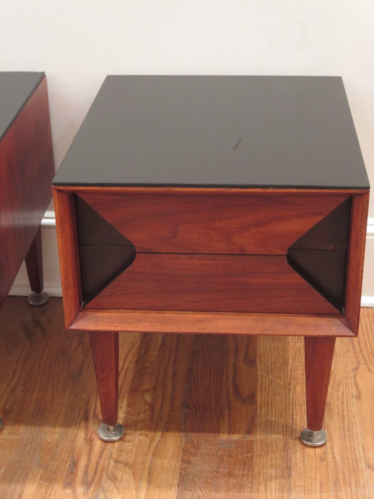 Pair of walnut night or end tables designed by Marc Berge. Black glass tops. Excellent condition.
