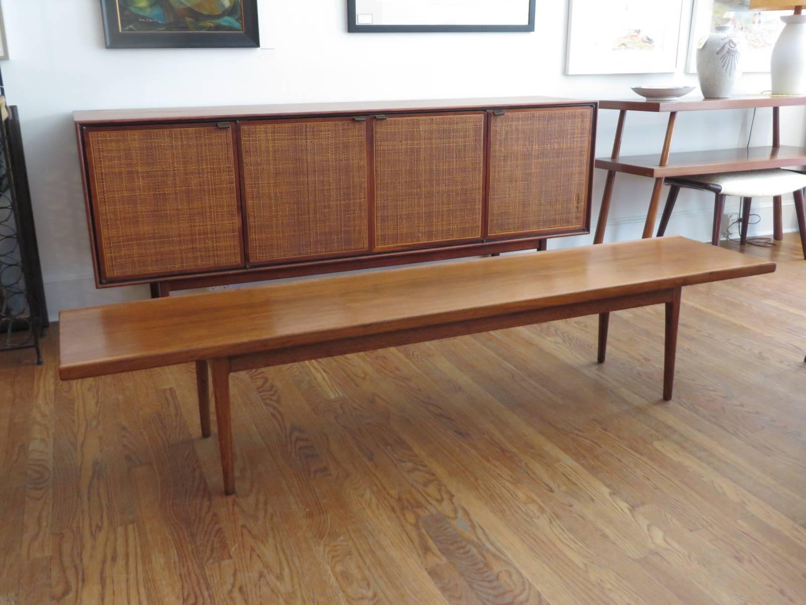 Mid-Century walnut bench/coffee table designed for the declaration line by Drexel.