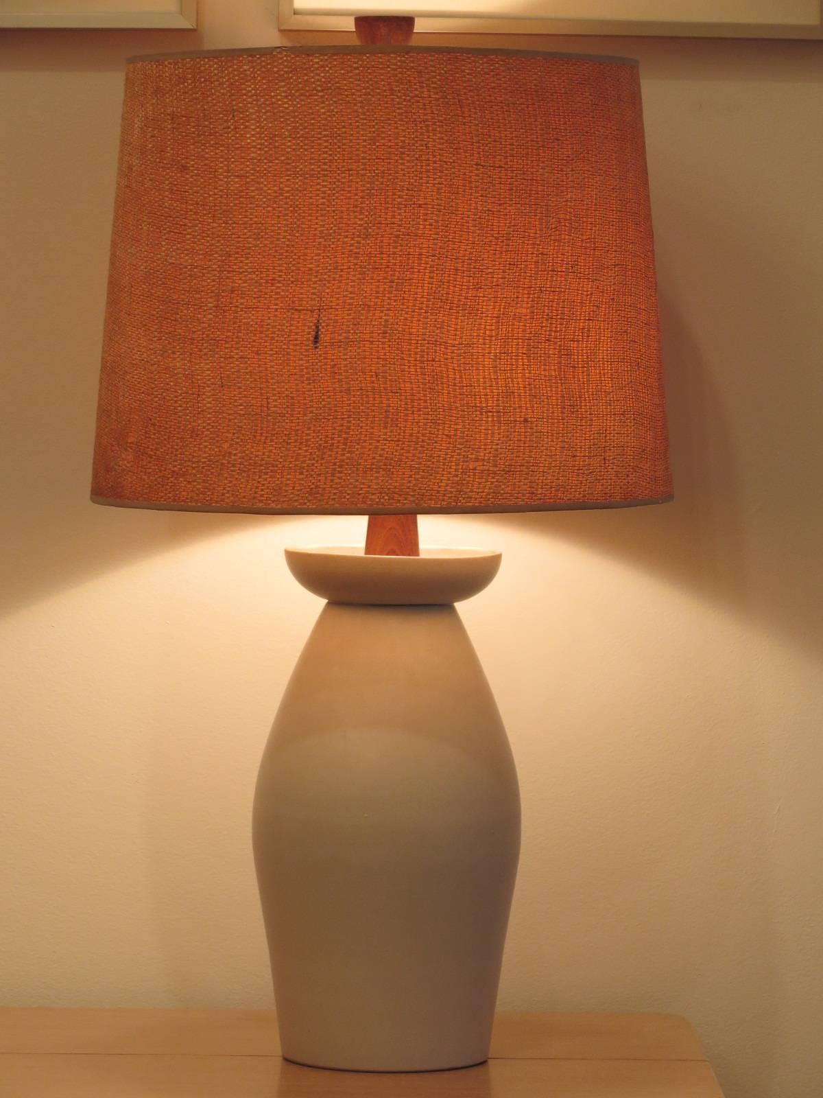 Iconic off white Martz table lamp with original shade. Wood finial, signed Martz.