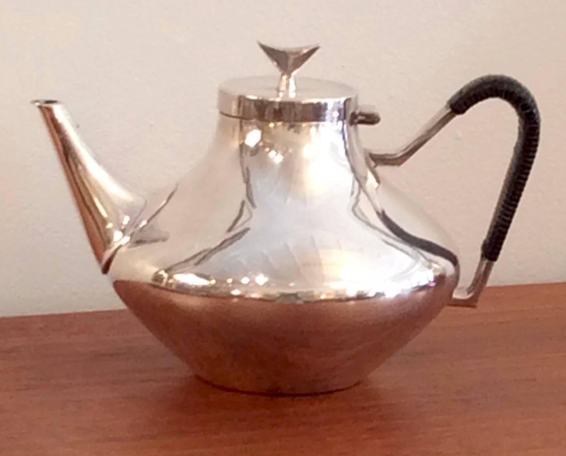 Elegant teapot by Scandinavian designer John Prip for Reed & Barton. Original woven detail and marked on bottom. Please note that we also have a matching coffee pot sold separately.