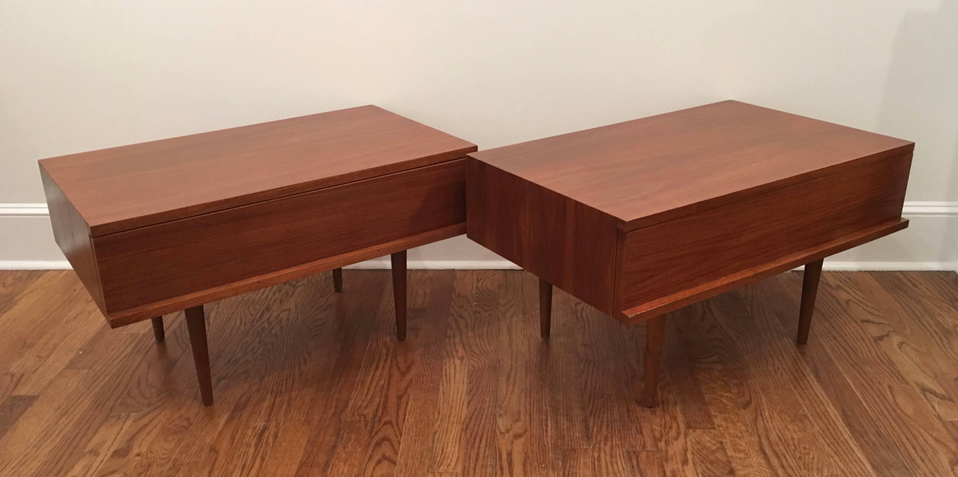 A rare pair of 1960s end/night tables designed by Mel Smilow. Walnut is bookmatched and has a beautiful grain and patina. Drawer handles are sculptural. Very elegant.