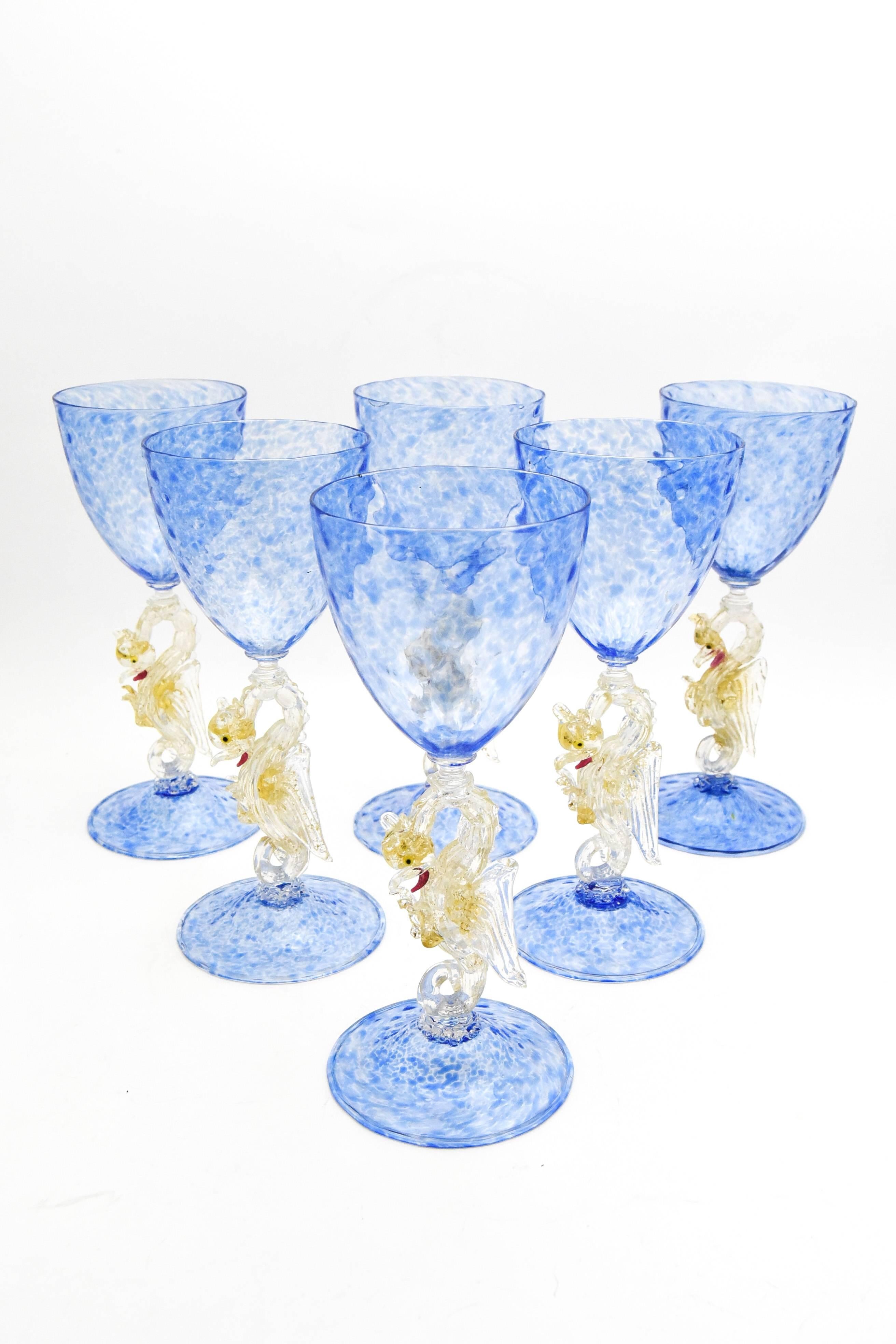 This an amazing set of eight tall, hand blown quilted optic ribbed French blue water goblets or chalices. Six goblets are pictured but there are 8 in the set. The clear connectors separate the blue bowl and foot, each a body in motion. The full