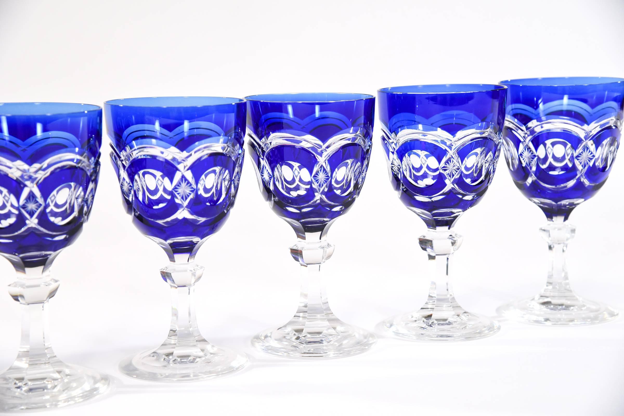 This set of 12 Val Saint Lambert handblown crystal cobalt blue goblets are cut to clear in one of the rarest patterns they made. The size is perfect for both water or wine, it feels substantial in the hand and makes a dramatic statement on the