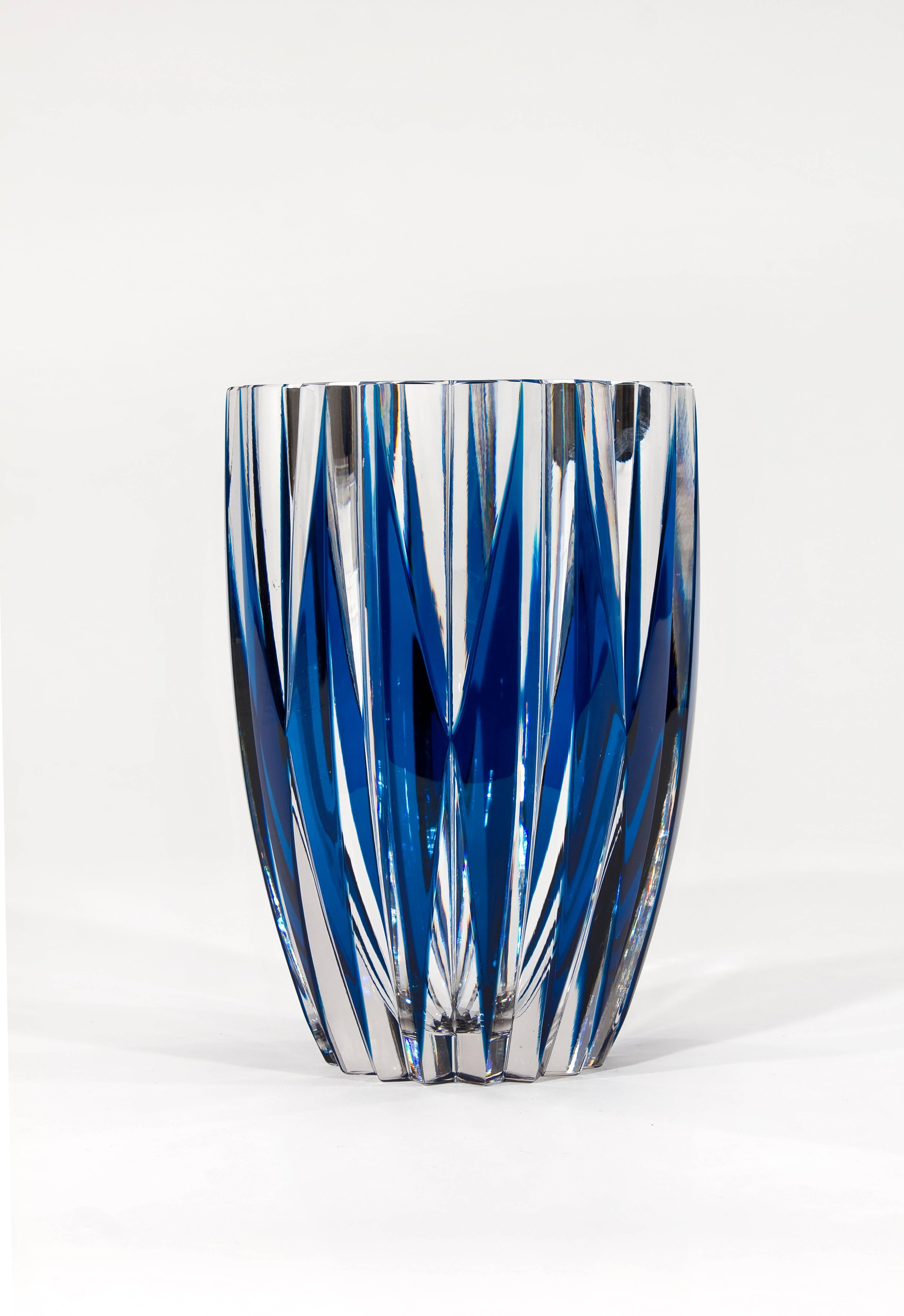 This signed St. Louis handblown crystal vase is a perfect example of the company's incredible workmanship. The thick, handblown crystal blank is cut in a complex geometrically perfect pattern of alternating diamonds of teal blue contrasting with