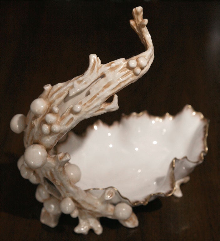 This figural porcelain grape stand and holder is decorated with whimsical mushrooms encircling the 