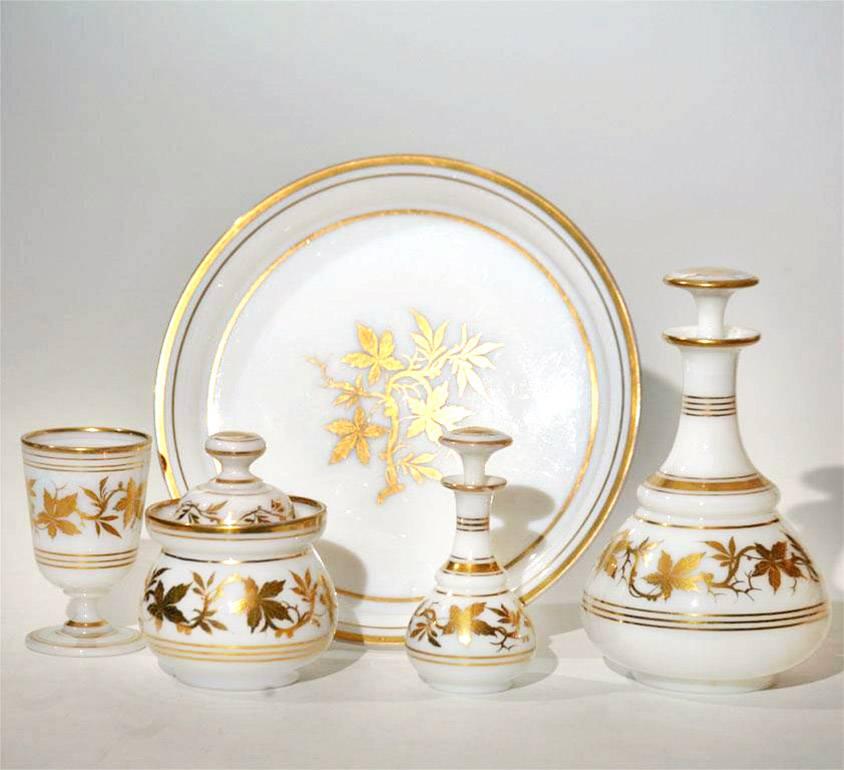 This complete and original handblown opaline crystal water set sits perfectly on the circular matching tray. Each piece has hand-painted gilded decoration in a leaf motif. This set has wonderful "fire" and luminescence to the glass,