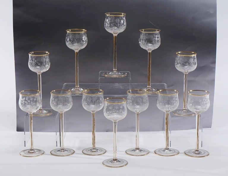 This set of 12 tall and elegant handblown crystal goblets feature a masterfully wheel cut Art Nouveau floral motif. Standing 8