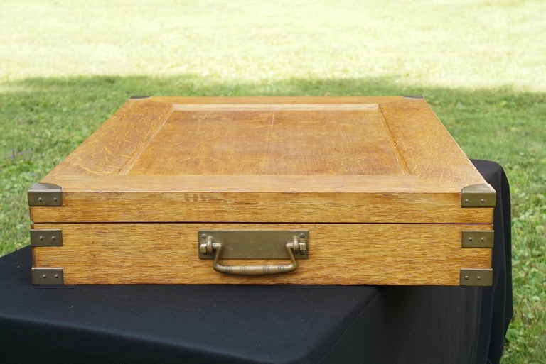This incredibly large and elegant box/chest was made for Tiffany and Company to hold a large sterling silver service.The red chamois lined interior features removable inserts for each size and piece of silver.The beautifully grained oak box is