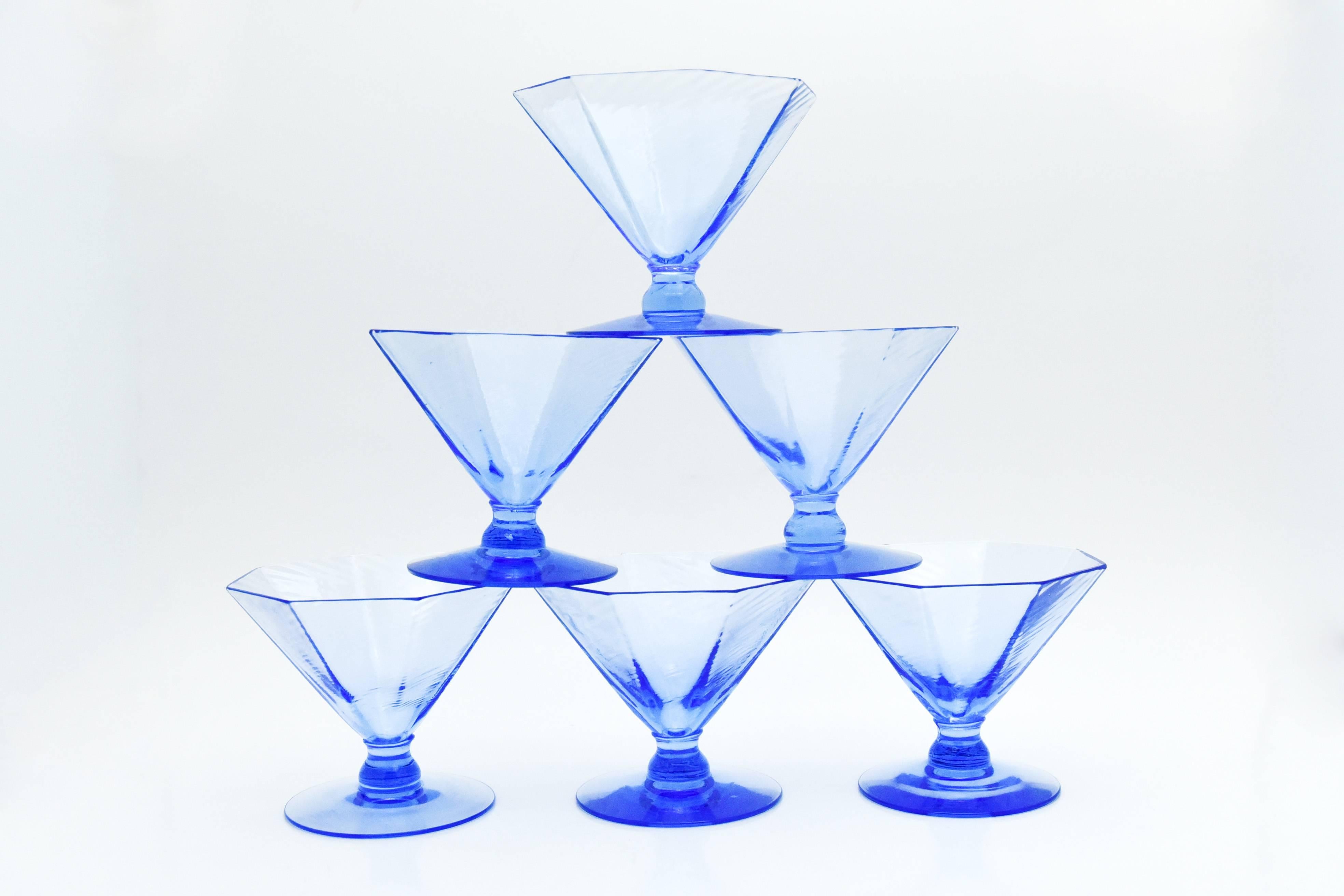 This unusual set of ten handblown, French, blue dessert/sherbet coupes were made by the Fry Glass Company. These Art Deco footed coupes feature an elegant octagonal shape that pairs beautifully with many different styles and periods. The delicate