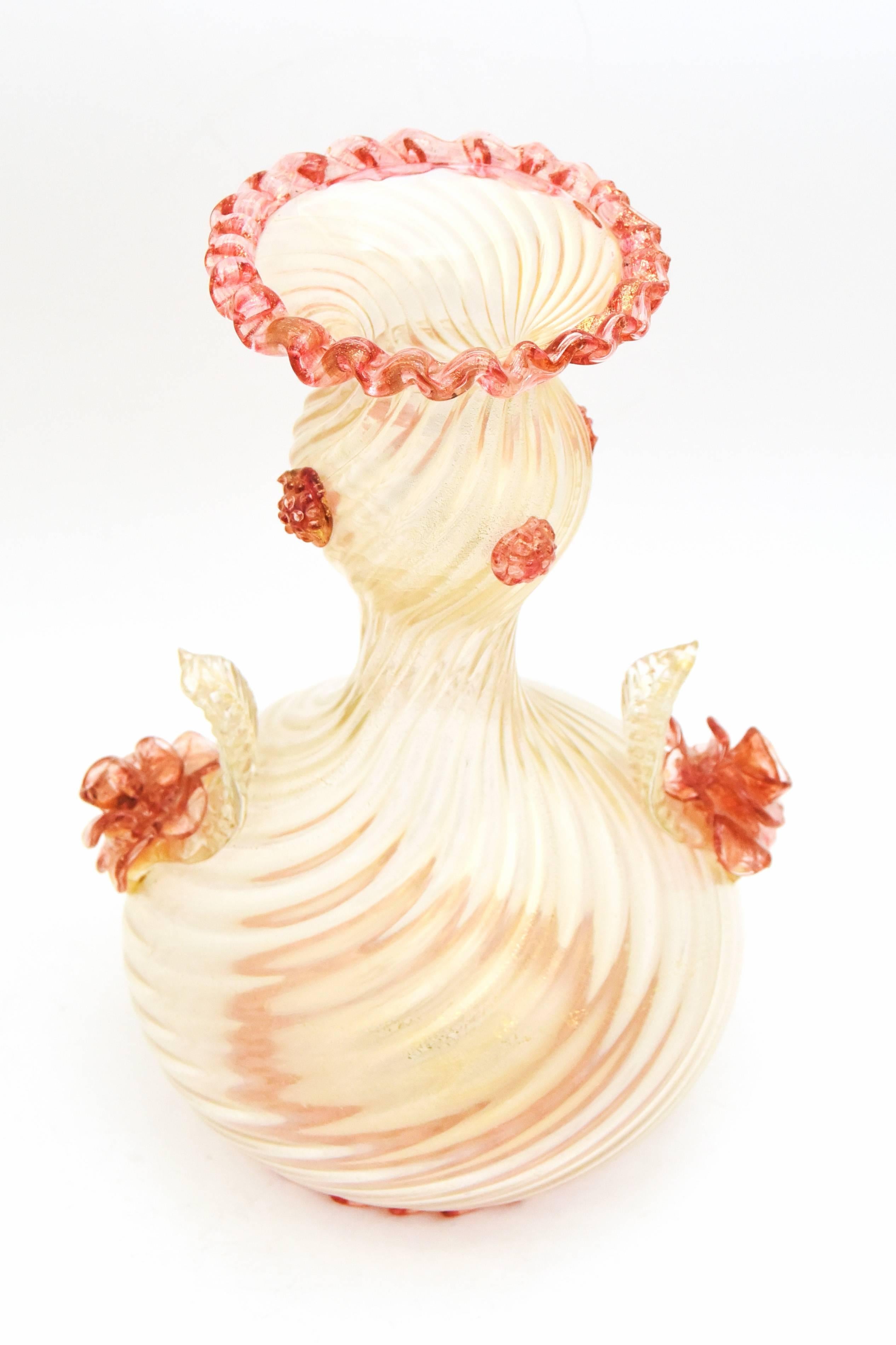 This is an unusual handblown Venetian Murano large vase with gold leaf infused ribbed glass. Made by Barovier e Toso, it is embellished with applied roses and matching rose-colored trim at the base and opening and applied prunts, to add to the