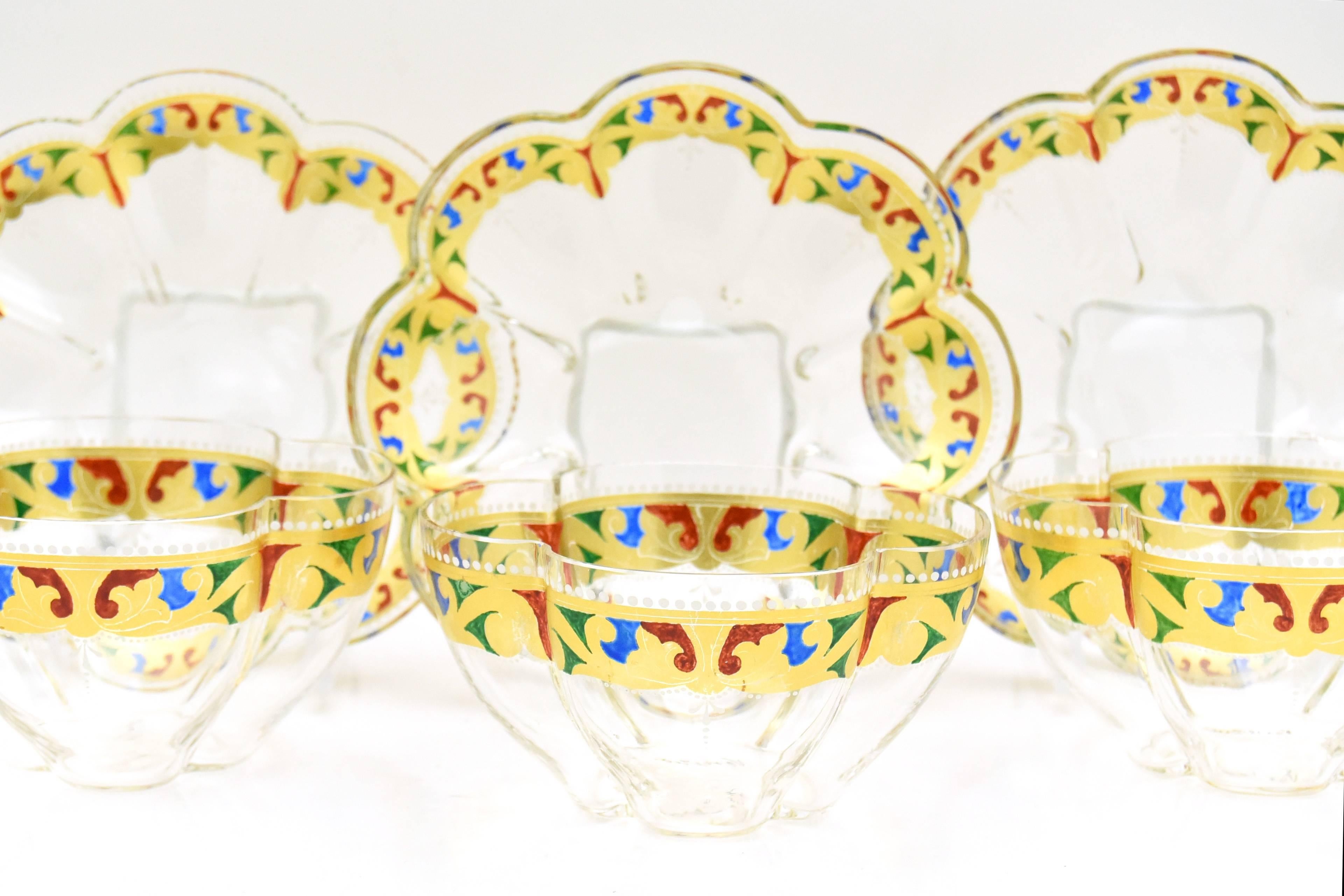 This is an amazing set of 12 handblown bowls and 12 matching under plates in a quatrefoil shape attributed to Salviati. They are expertly decorated in primary jewel tones and the vibrant colors allow them to work beautifully with so many color