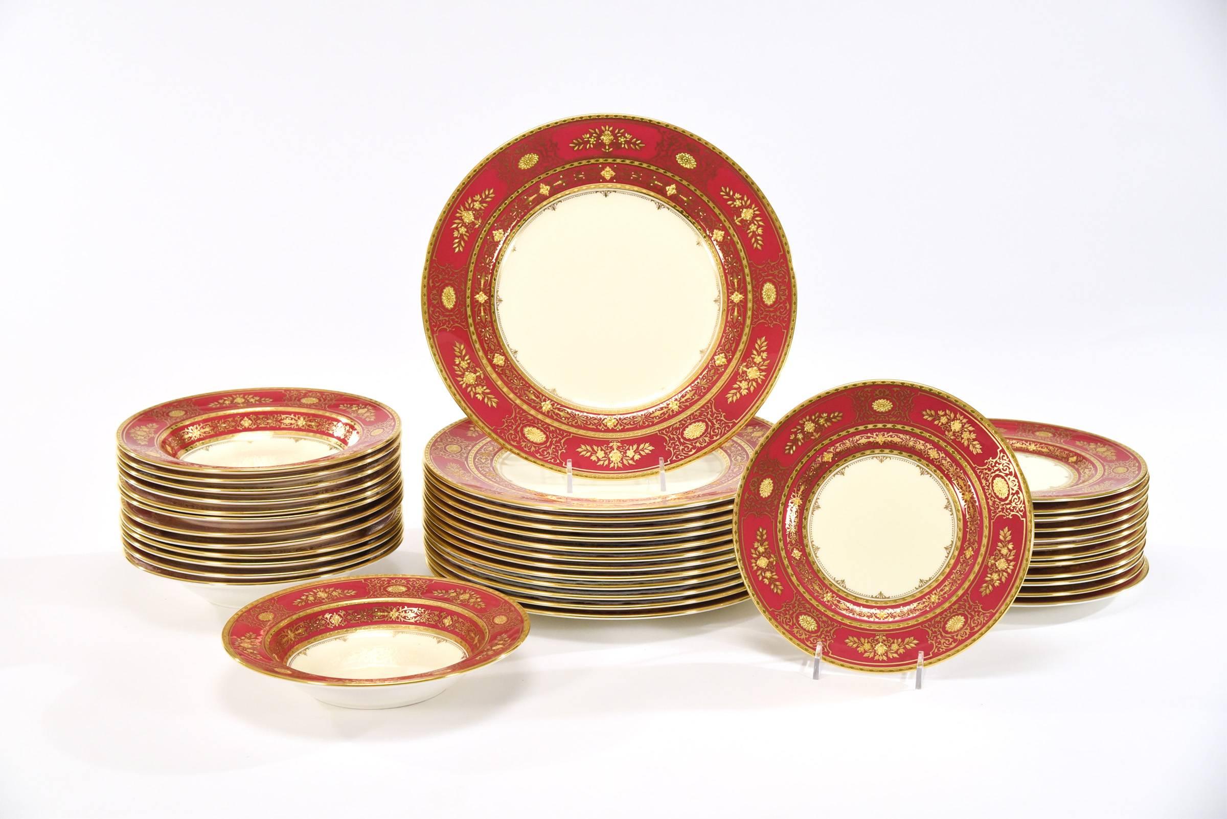 This is a fabulous dinner service made by Minton for Tiffany with a custom-order red/burgundy border, ready for holiday entertaining! The centre ground is a soft ivory, providing a dramatic contrast to the borders which are decorated in an elegant