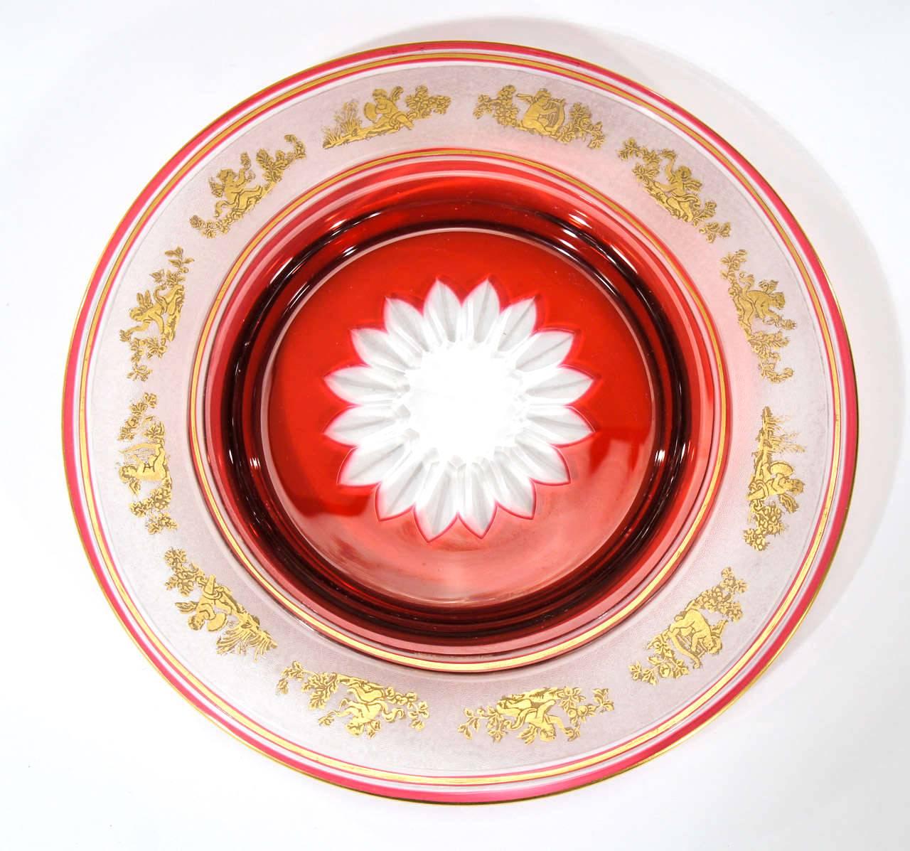 A rare and amazing set of 12 gorgeous dessert plates with cranberry overlay, cut to clear with central star cut medallion and cameo cut frieze of Roman putti and angels embellished with gold leaf. This pattern is one of Val St. Lambert's finest and