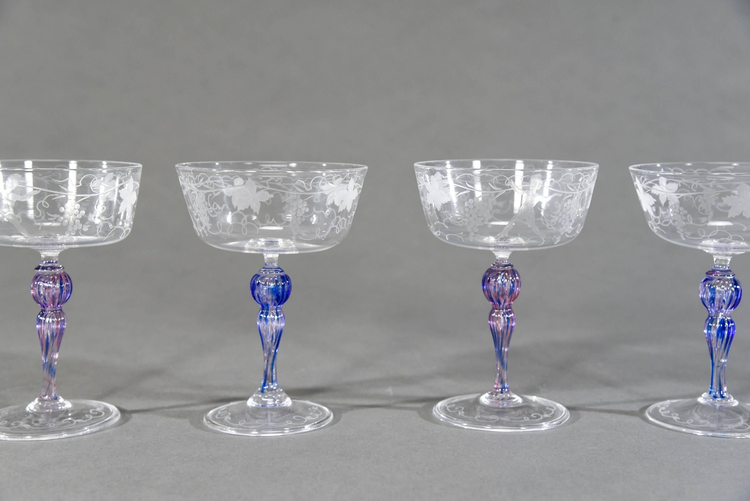 What a fabulous grouping of 15 hand blown Venetian champagne coupes and also perfect for your favorite martini! Each one is engraved with grapes, leaves and vines surrounding the bowl, interspersed with young Bacchus figures romping through the
