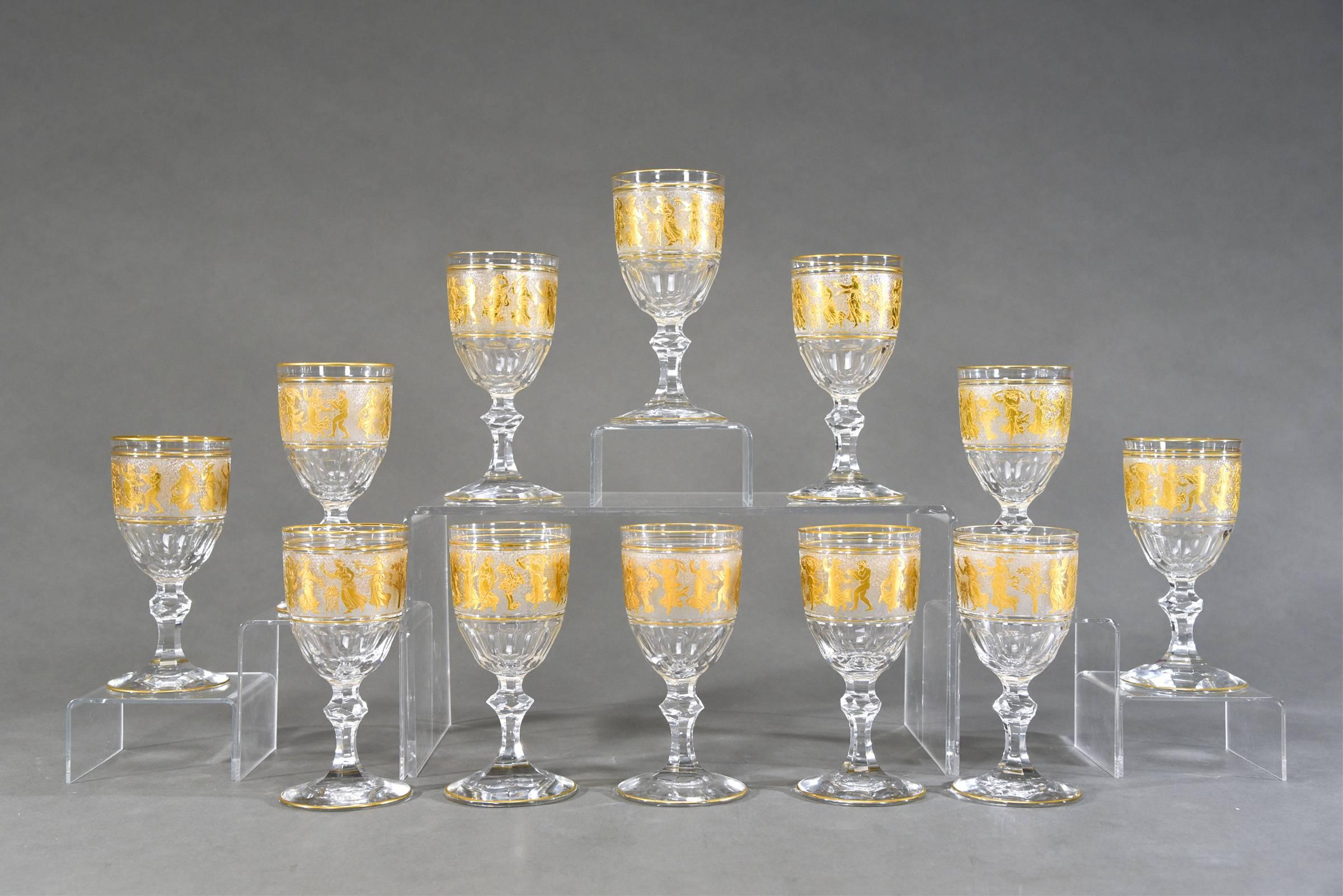 This is a magnificent set of 12 water or wine goblets made by Val St. Lambert. Each one is handblown, panel cut bowl with cameo cut frieze of Roman figures embellished with gold leaf. This pattern is one of Val St. Lambert's finest and creates a
