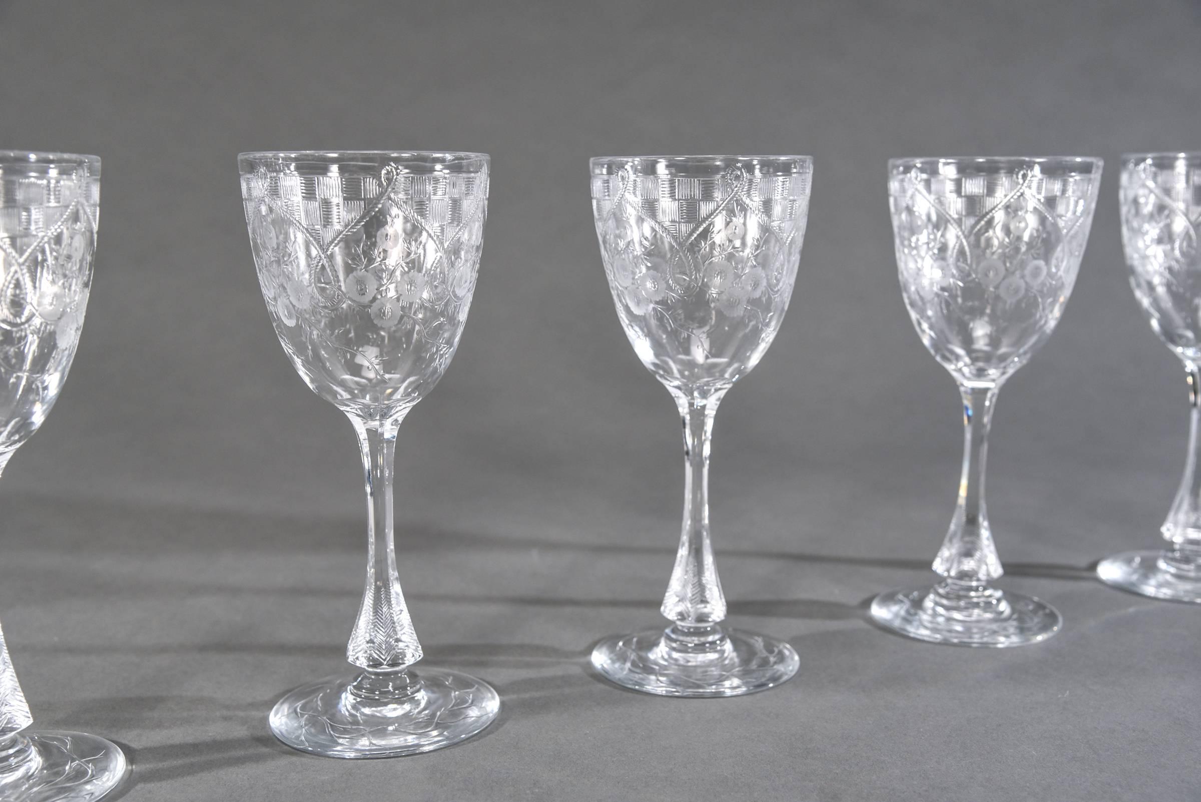 This is a fabulous set of 16 handblown crystal goblets made in England by Webb Corbett. What makes these stand out is their size as well as the unusual engraved decoration. The wheel cutting incorporates both linear and floral design making these