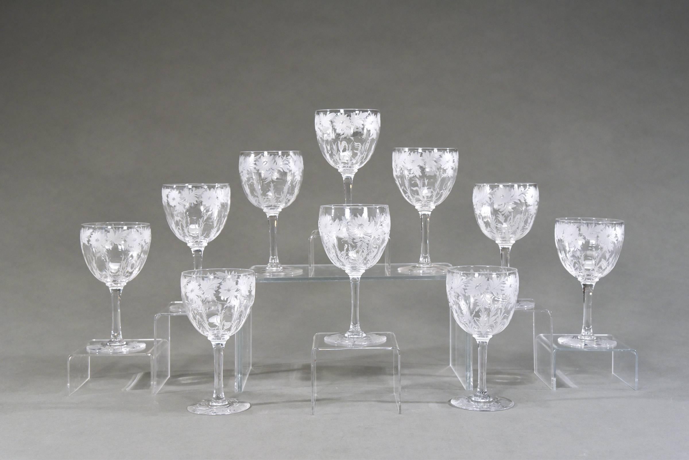 This set of 12 signed Libbey handblown goblets depict an iconic Arts and Crafts pattern of wheel cut flowers alternating with leaves along the rim. The engraving remains frosted which gives them a wonderful contrast to the clear crystal bowl. The