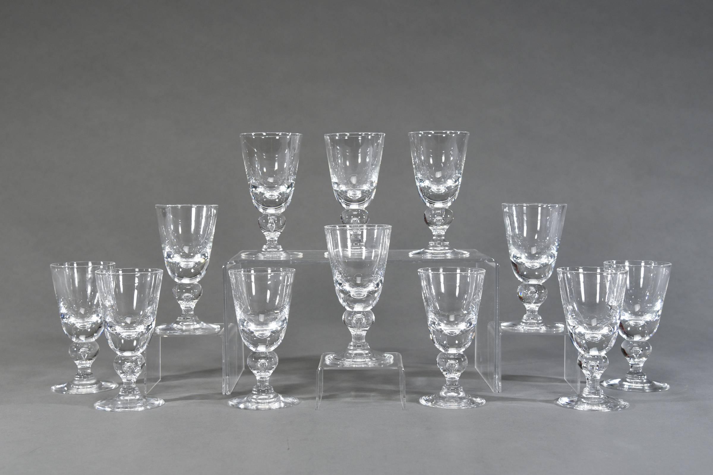One of the most desirable patterns of Steuben's clear stemware services is this Classic baluster shaped goblet, pattern # 7877, designed by George Thompson. Handblown crystal with a low center of gravity, the perfect weight, which feels amazing in