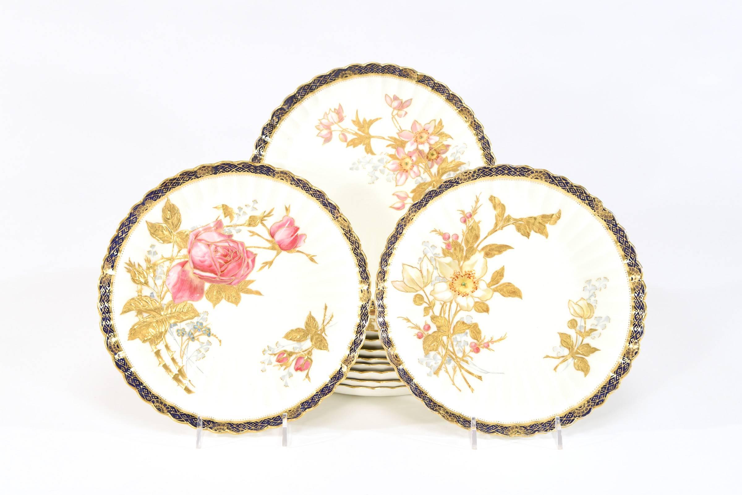 This beautifully decorated dessert set is hand painted with polychrome enamel floral decoration in the iconic Aesthetic Movement style featuring 10 different flowers all placed off center and embellished with raised paste gold. Each plate is