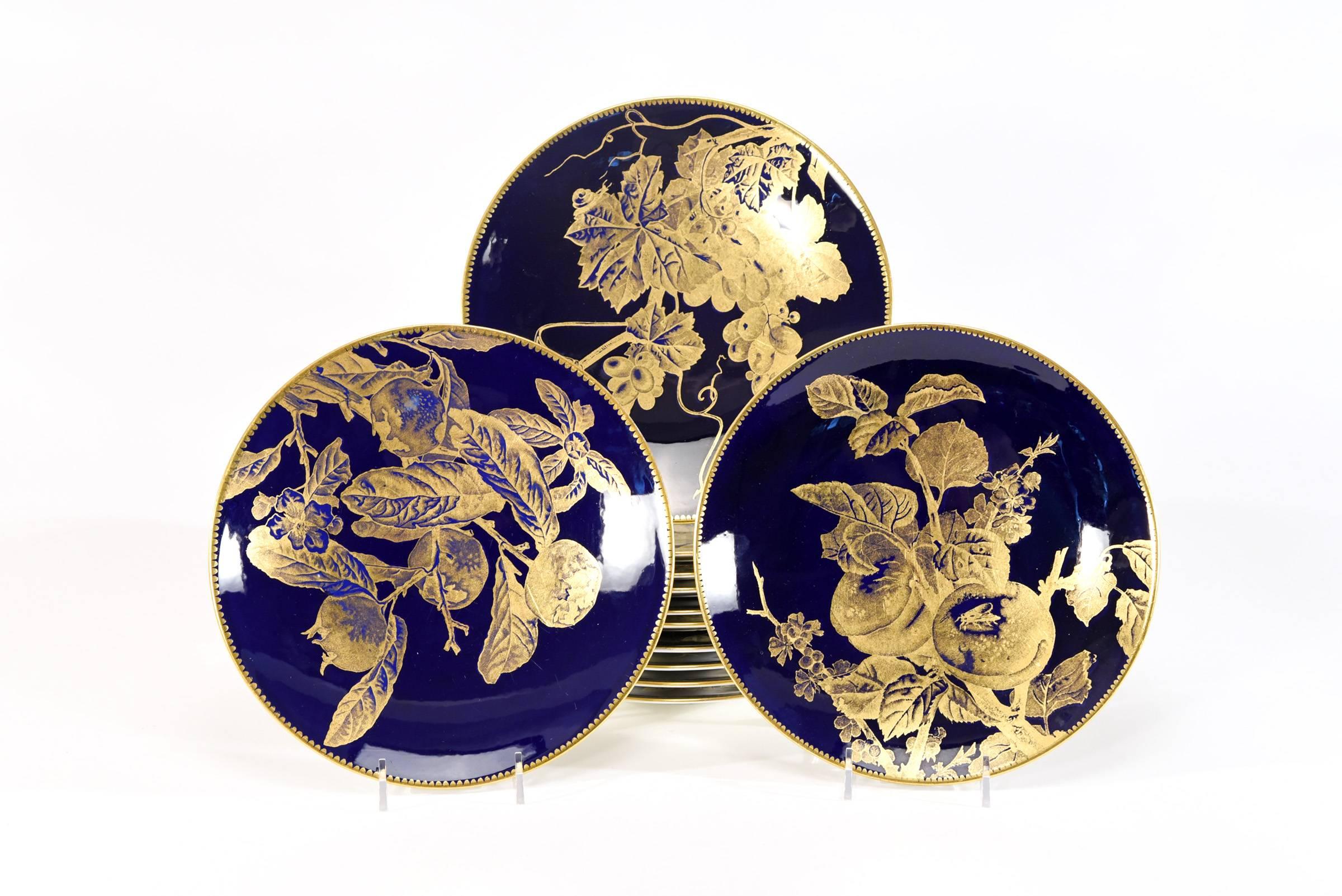 This set of 12 Brownfield 19th century dessert plates exemplify the Aesthetic Movement at its finest. Each plate is uniquely decorated with a gold overlay depicting different fruit specimens, including insects and foliage, all placed off center in