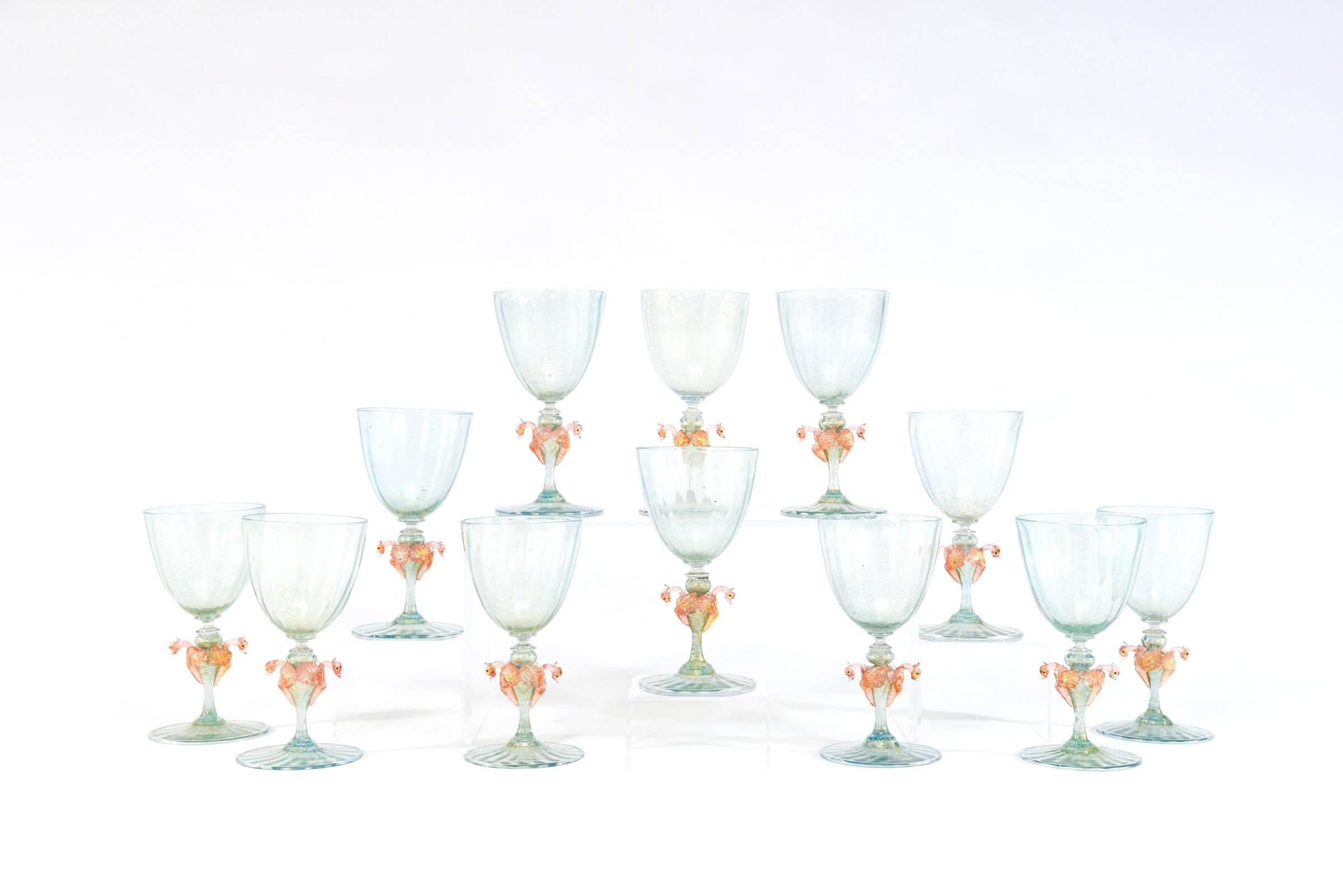 This is an amazing set of 12 handblown Venetian goblets with gold leaf inclusions and optic ribbing made in an unusual color combination. They are green with shades of blue to create aqua. The size is perfect to use as both wines and water goblets