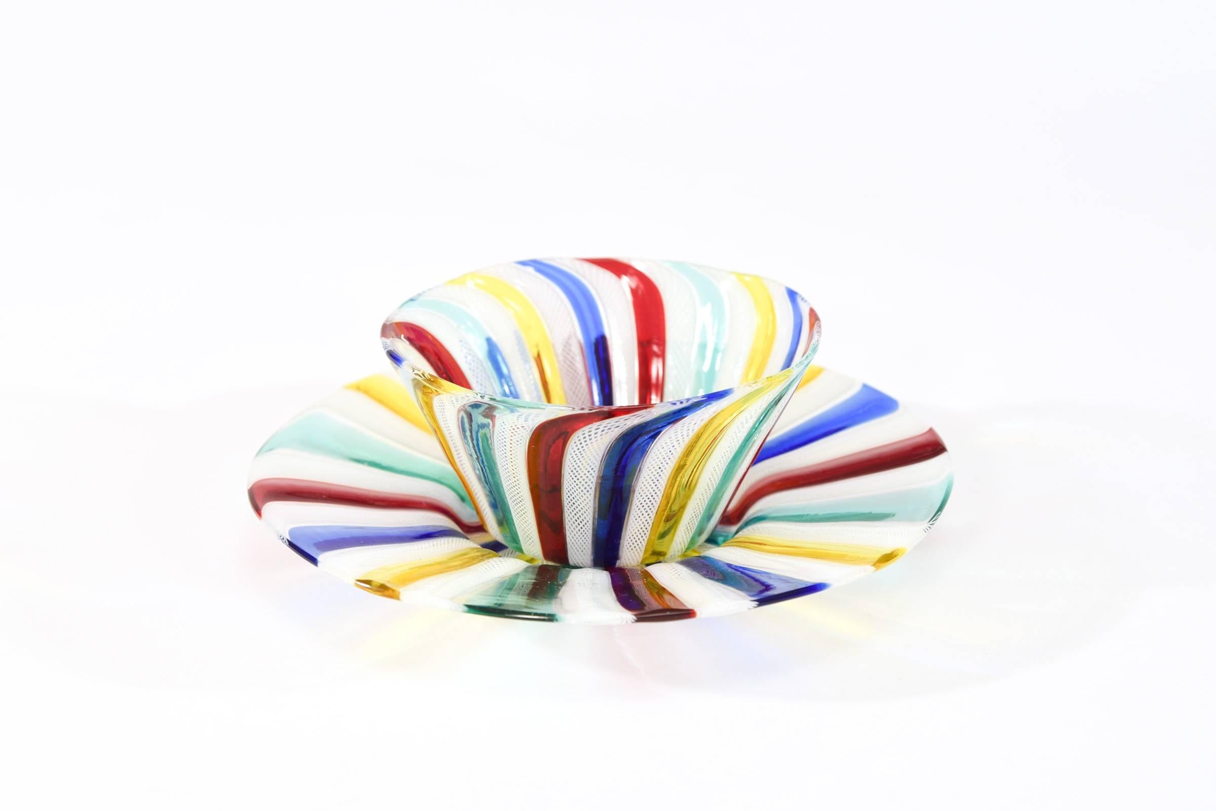 This set of 8 hand blown bowls and matching under plates were most likely made by Salviati and what sets them apart is the eye catching use of rich and dramatic primary colors. The brightly colored rods alternate with white latticino rods, creating