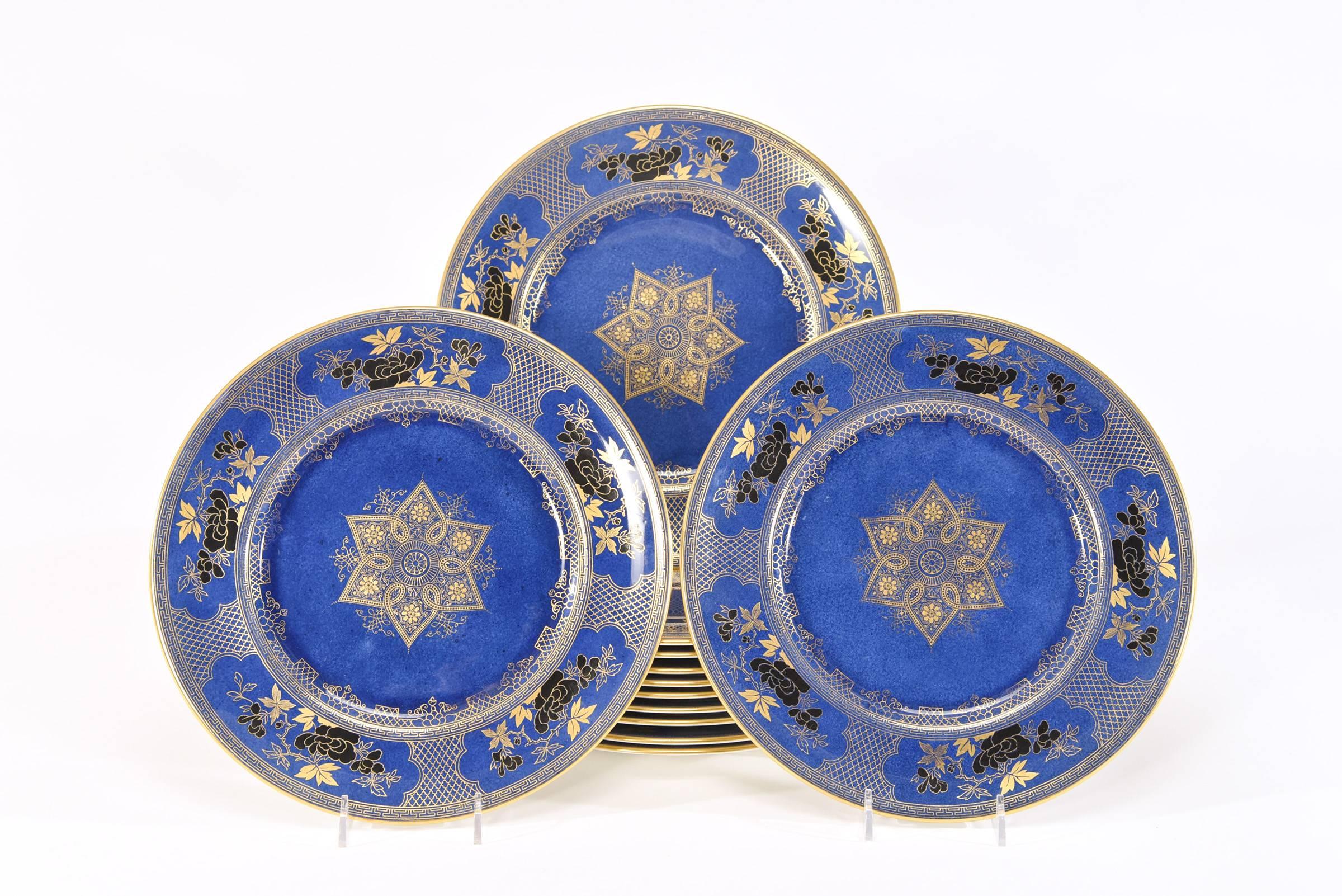 This set of 12 Royal Doulton capture the essence of the Japonism decorative elements with the Aesthetic Movement motif. Five reserves encircle the border with black and gold enamels alternating with a gold latticework on a lapis blue ground. The