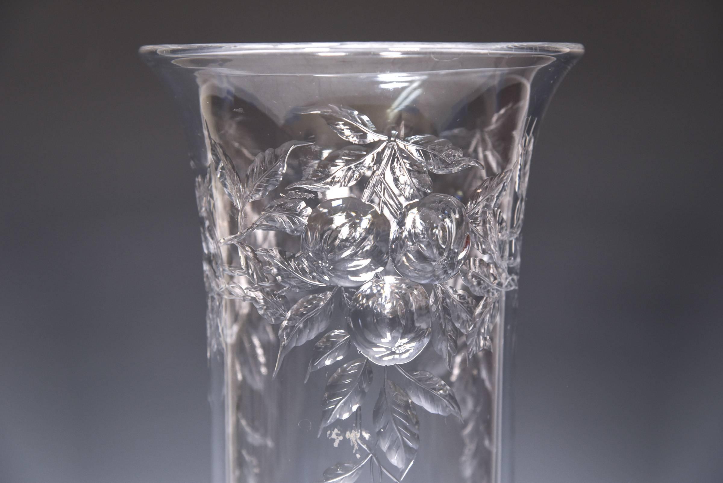This is a familiar wheel cut motif that Baccarat used on vases and tazzas and this is beautifully executed on this tall vase. The solid and substantial clear blank is elegantly decorated on both the flaring top rim and base with fruit and leaves