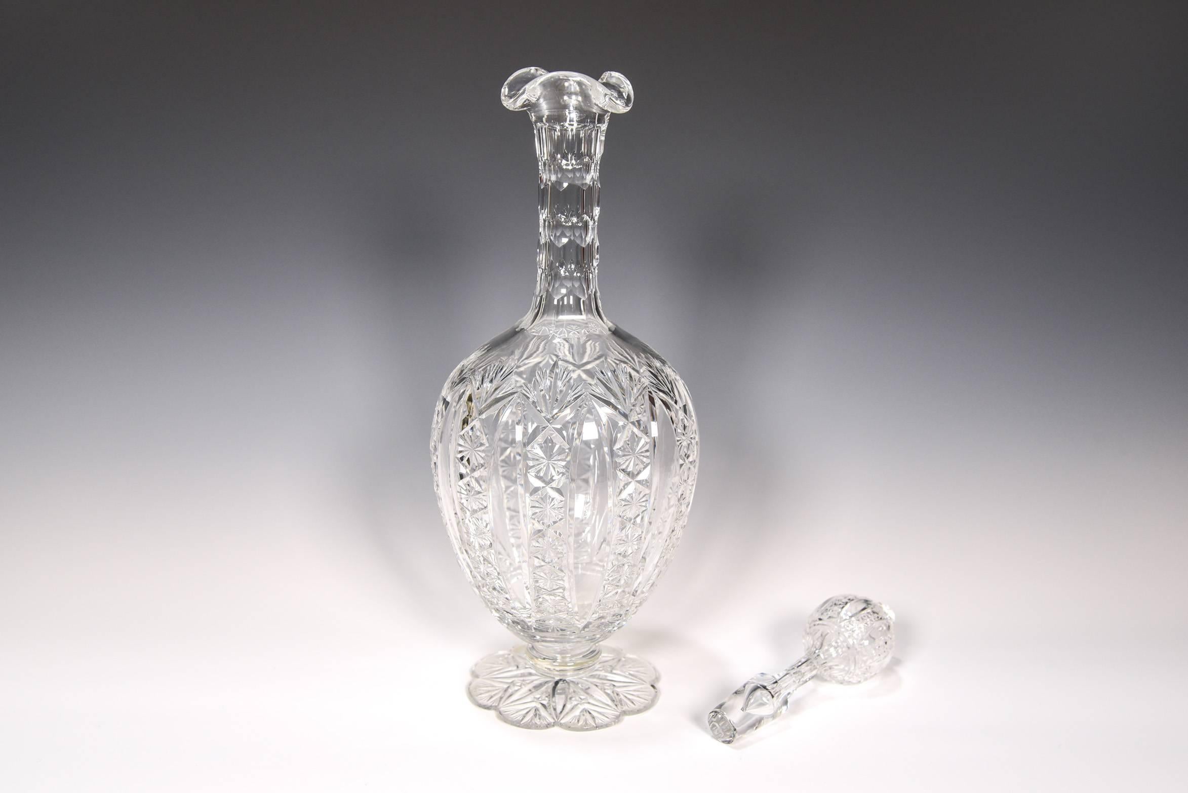 This beautiful decanter is handblown crystal made by the Cristalleries De Baccarat. It is decorated in the most complex and masterful Conde pattern, first introduced in 1908 with amazing intricately cut and notched stems and spreading petal cut