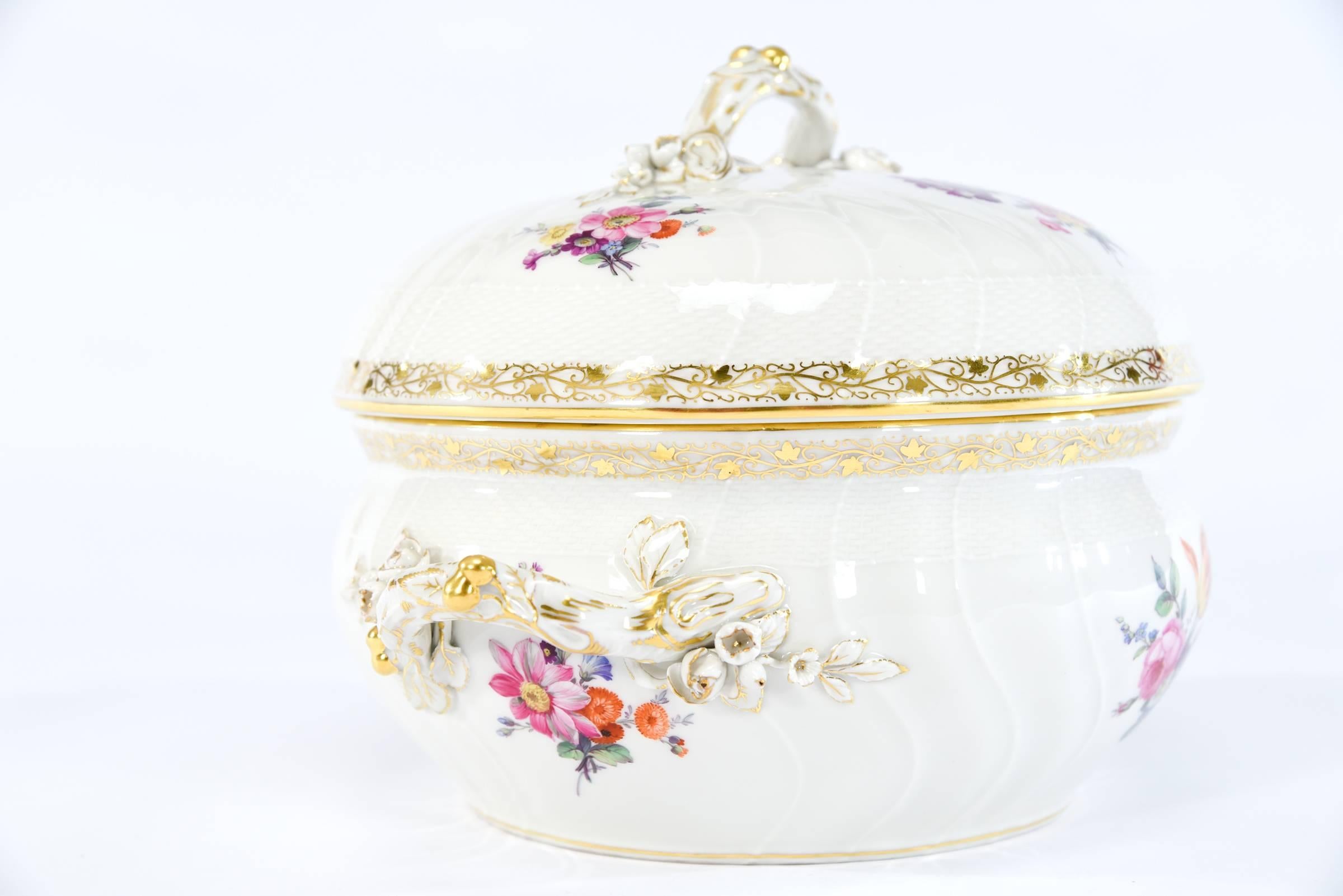 Sometimes it's nice to have a classic round soup tureen and this one made by KPM is a perfect example. The molded round body is embellished with detailed hand-painted polychrome floral decoration and the handles are shaped like branches with molded