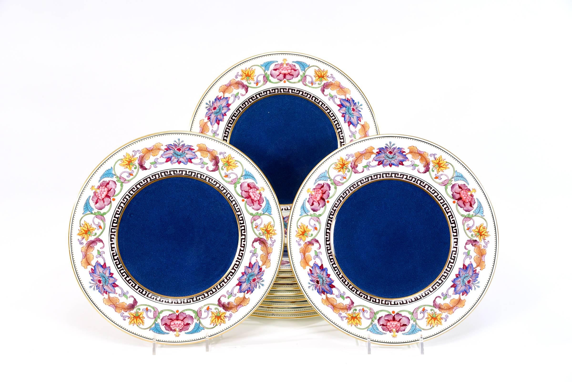 This is an unusual set of 12 Wedgwood lapis lazuli powder blue ground dinner plates with a polychrome Aesthetic Movement style enameled border. The beautiful combination of colors on the white border creates a dramatic contrast to the blue centers