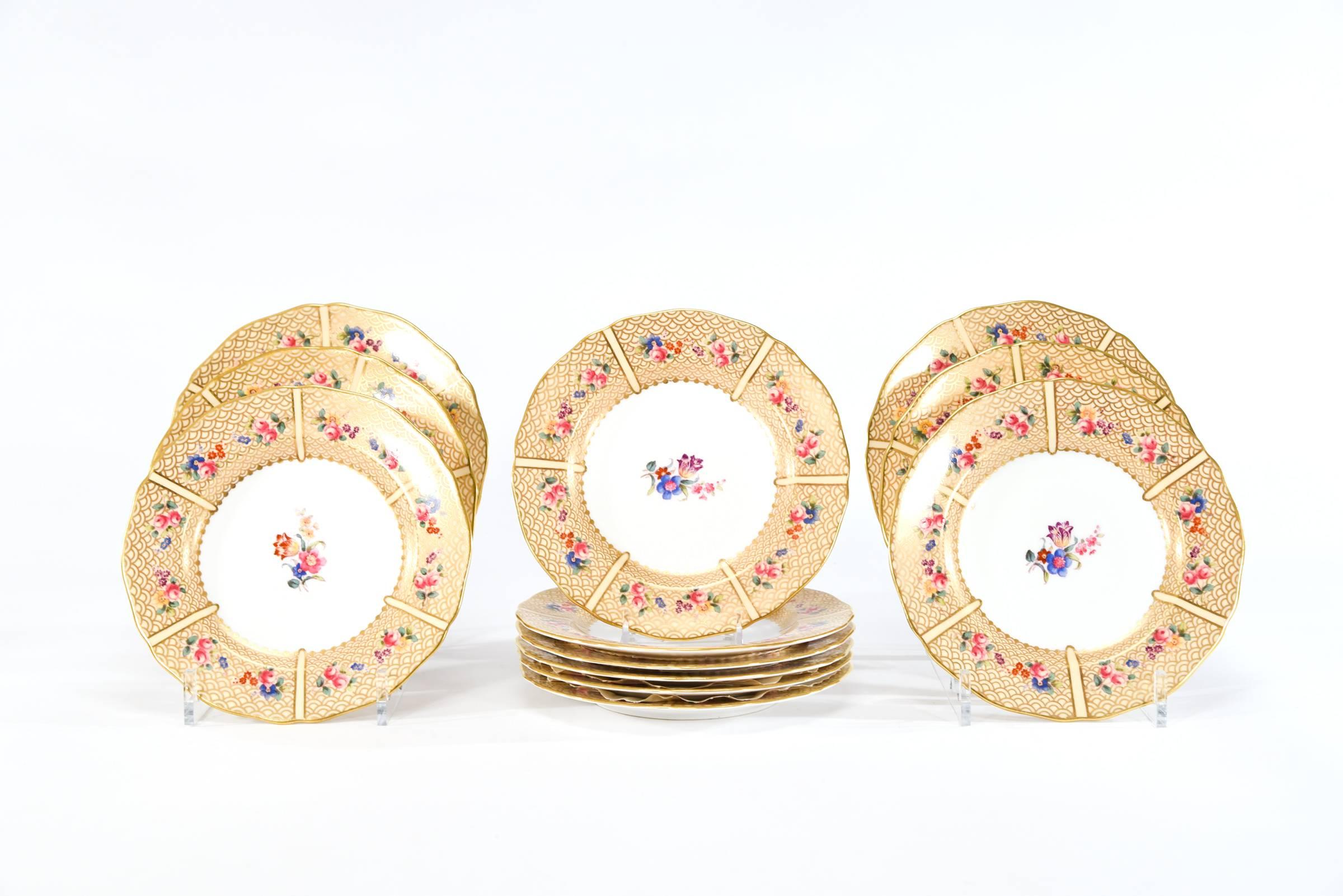 This is a complete dessert service for 12 that includes the matching coffee or teapot, creamer and sugar made by Copeland Spode, exclusively for Tiffany and Co.
The butterscotch colored enamel border is decorated with a series of multicolor flowers