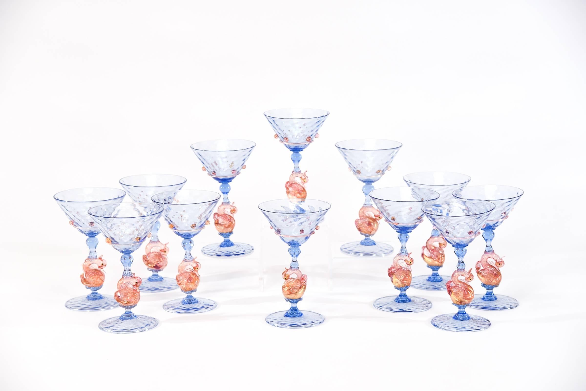 What an amazing Venetian Murano stemware service, ready for your next event in the bright and Classic French blue. Each piece is handblown in an optic rib pattern with applied pink prunts and figural swan connectors. All the sizes are practical and