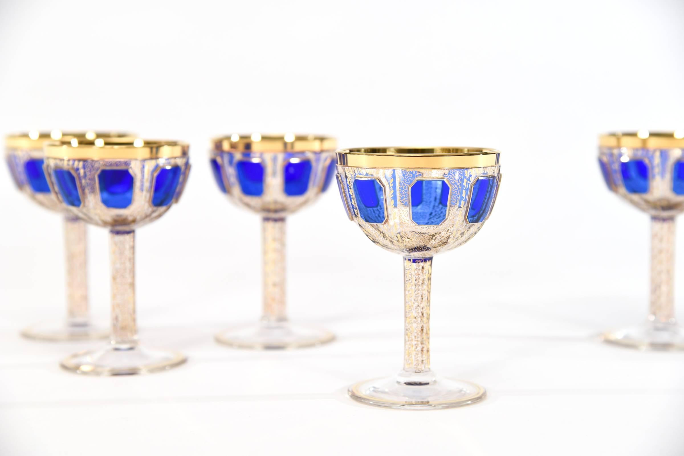 This set of eight Bohemian handblown crystal champagne goblets in the iconic coupe shape, are part of a larger matching set of goblets, made by Moser. They feature elongated raised panels of rich sapphire blue 