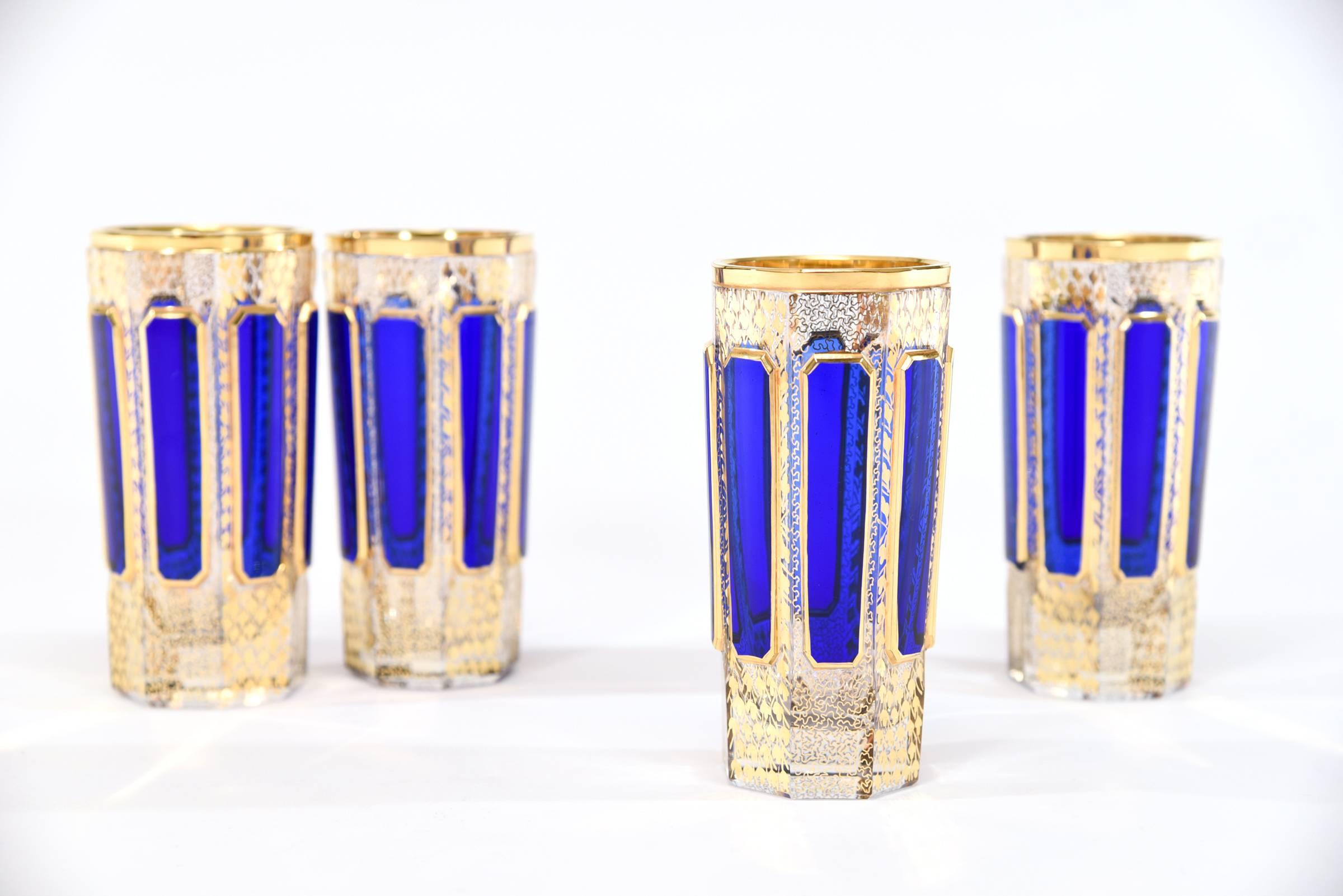 This set of eight Bohemian handblown crystal tumblers are part of a larger matching set of goblets, made by Moser. They feature elongated raised panels of rich sapphire blue 