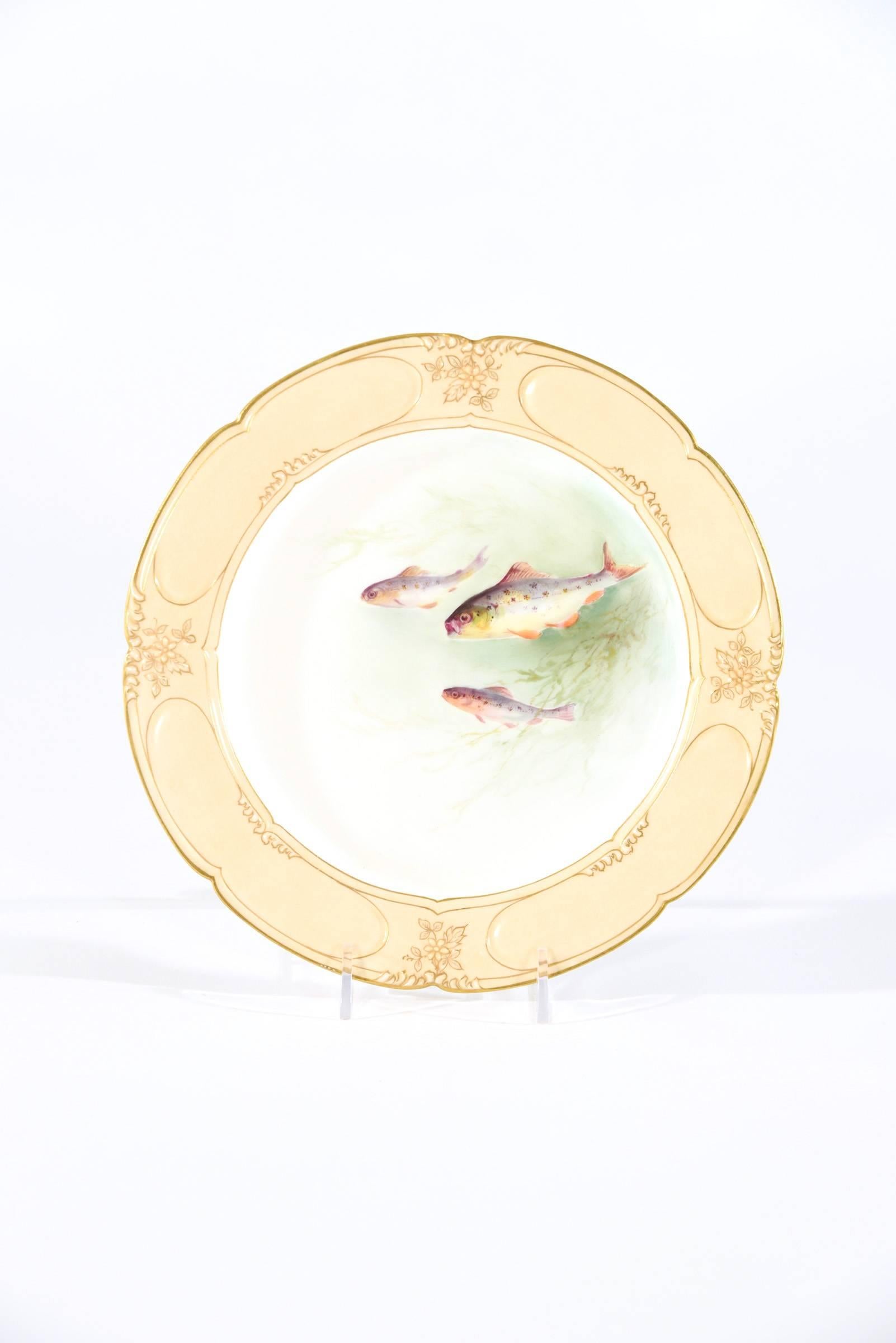 This set of 12 Doulton Burslem plates dates from the 1890s and are decorated in the Aesthetic Movement style. Each plate is uniquely hand painted with different underwater scenes of fish in motion in their natural habitat. The caramel colored border