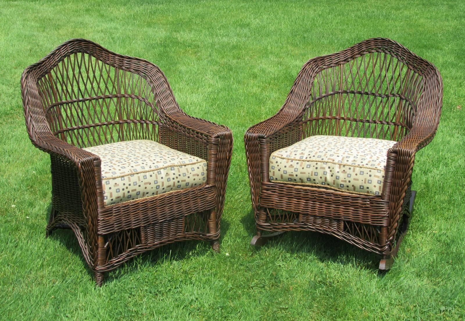 Matching pair bar harbor wicker armchair and rocking chair in dark natural stained finish. Combination of traditional bar harbor latticing and solid woven panels with crownback form to frames. Original inner-spring seat cushions professionally