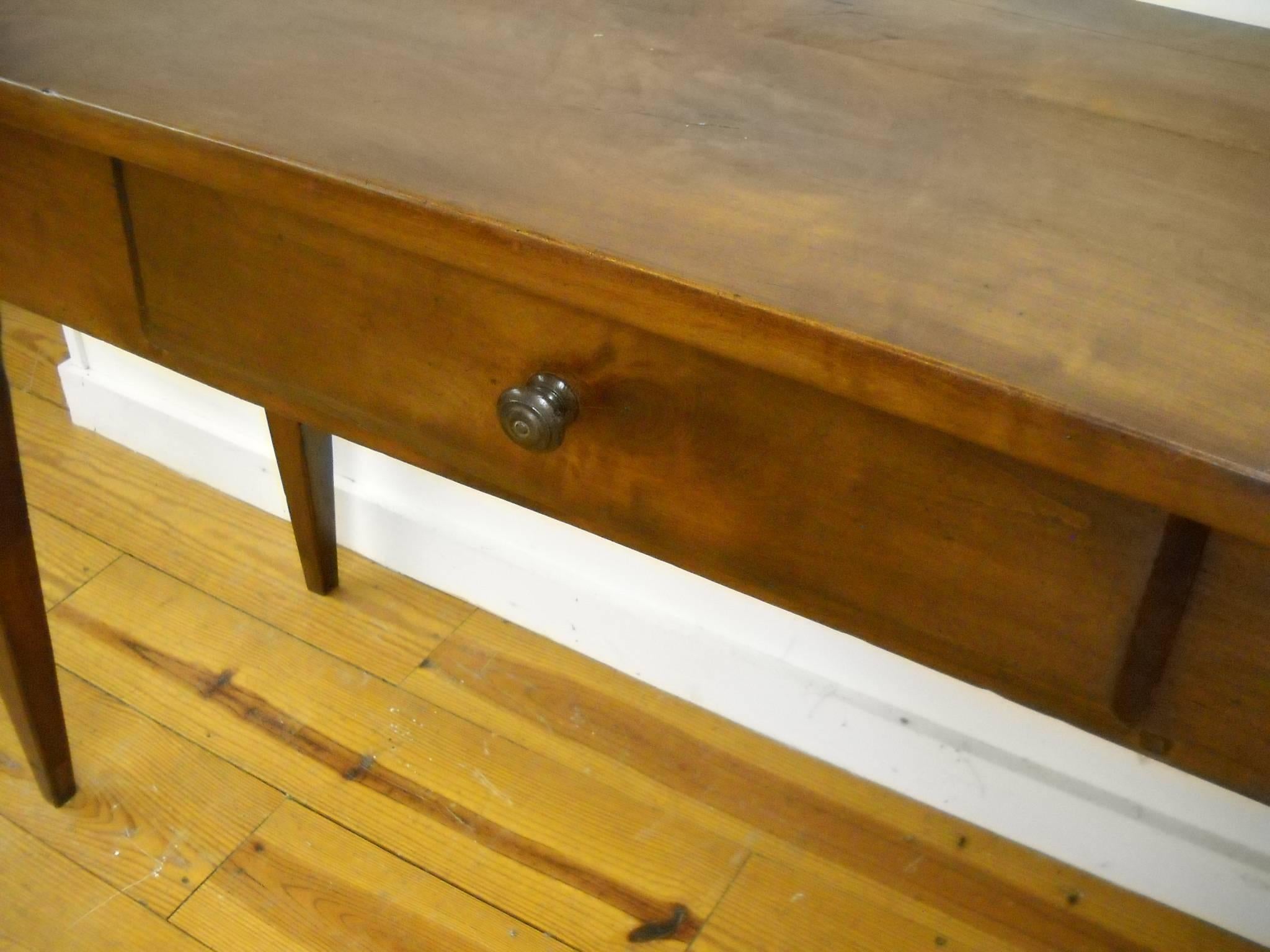 This French serving table has two drawers, each a different size. That was quite common for the French and adds great character to this piece. What dominates your eye on this server is the patina. It is gorgeous! In a hallway or under a long sofa