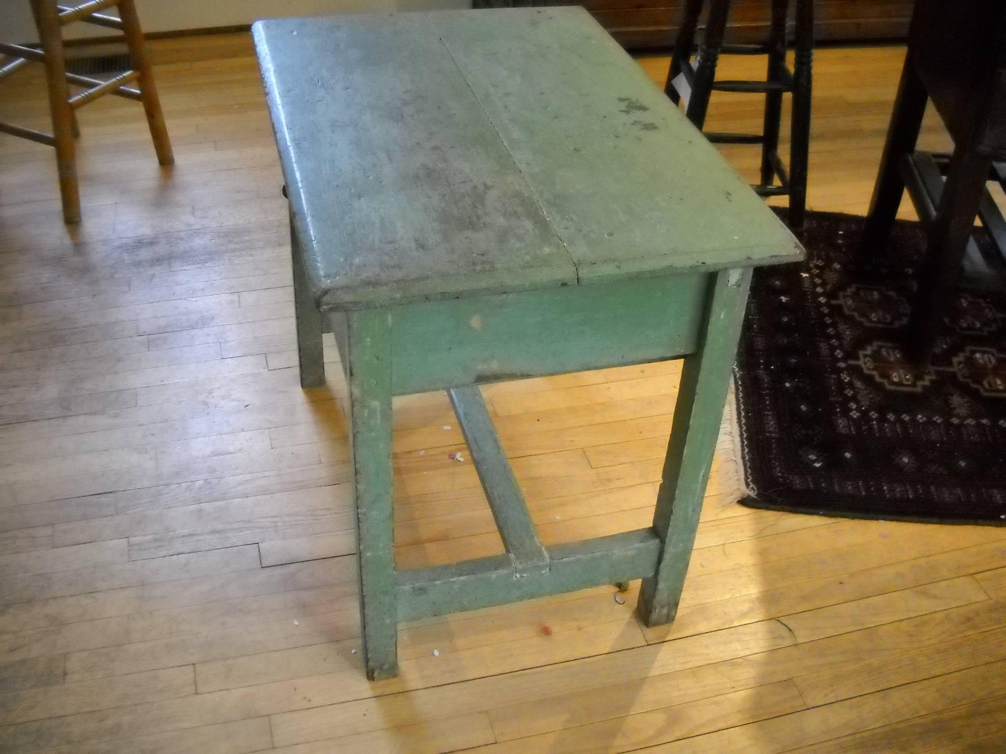 It's the soft rich green original paint that will get your attention first and then the large storage drawer for a small table. The T cross stretcher completes this very nice painted English table.