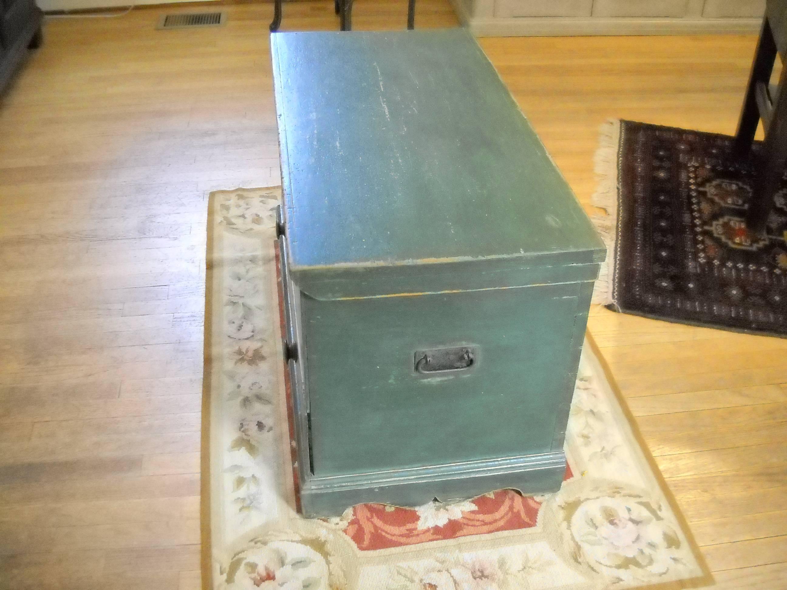 This rich green blanket box is unusual. Not only does it have storage on the top but there is a bottom drawer too. Everything is original to the piece, including the hinges inside and a sweet candle box inside and handles on each end outside the