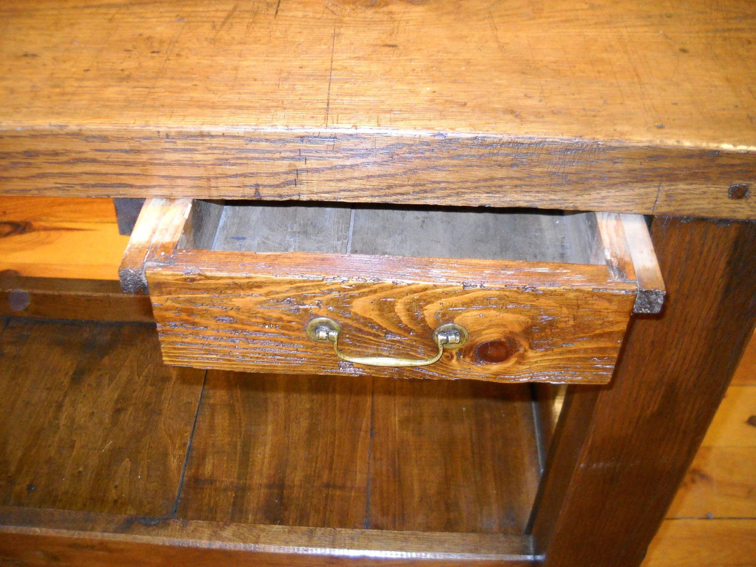 The most beautiful cobblers bench we have every found. Complete with its original vice this oak and chestnut table would be a terrific serving table or can be used freestanding, as it’s finished on all sides. The shelf on the bottom adds terrific