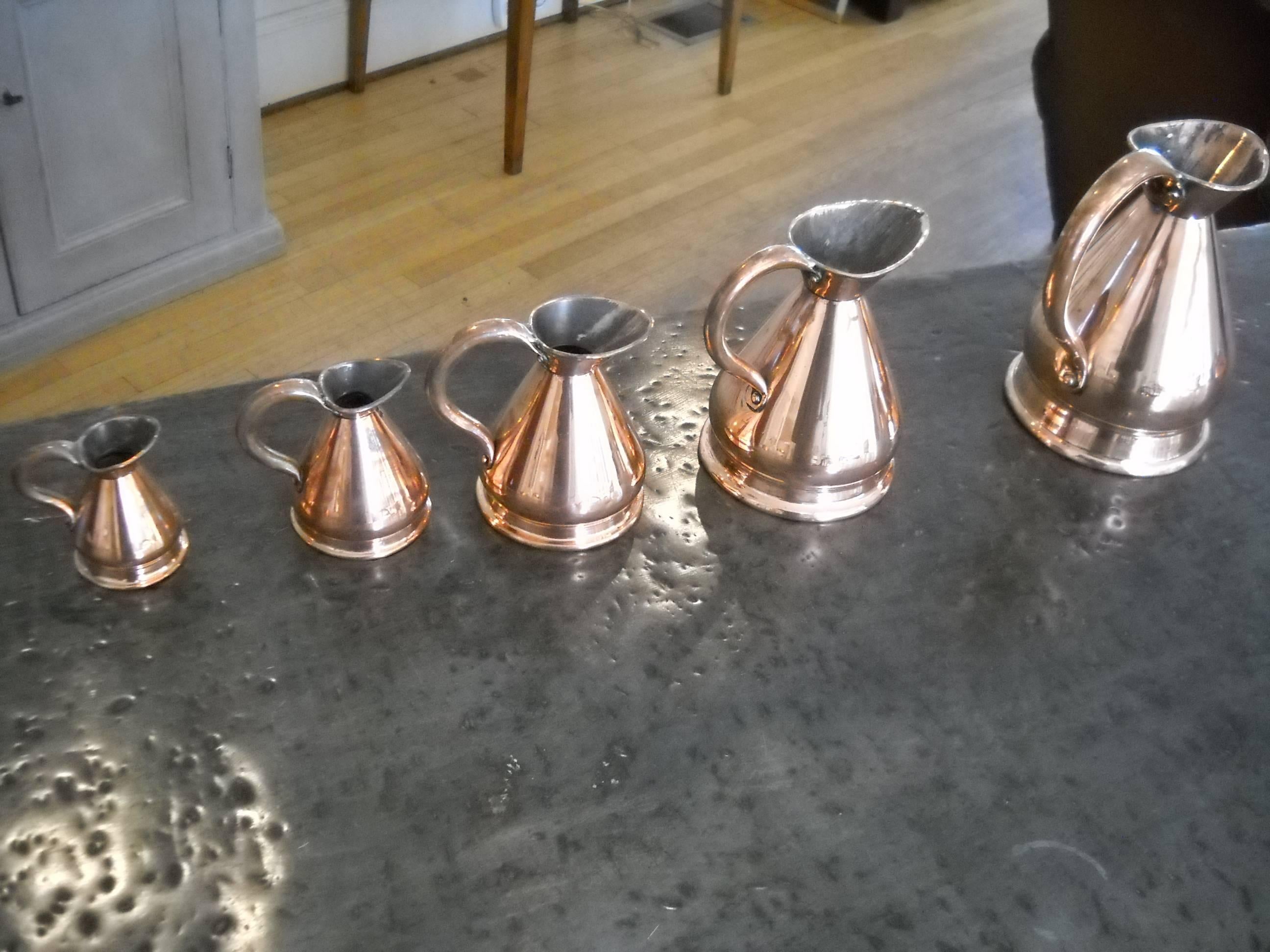 One of the most unique copper pieces we have ever found. This is a complete set of copper measuring pitchers. We have never found anything in copper quite like this. It is part of a very large collection of copper in our store. Simply the best