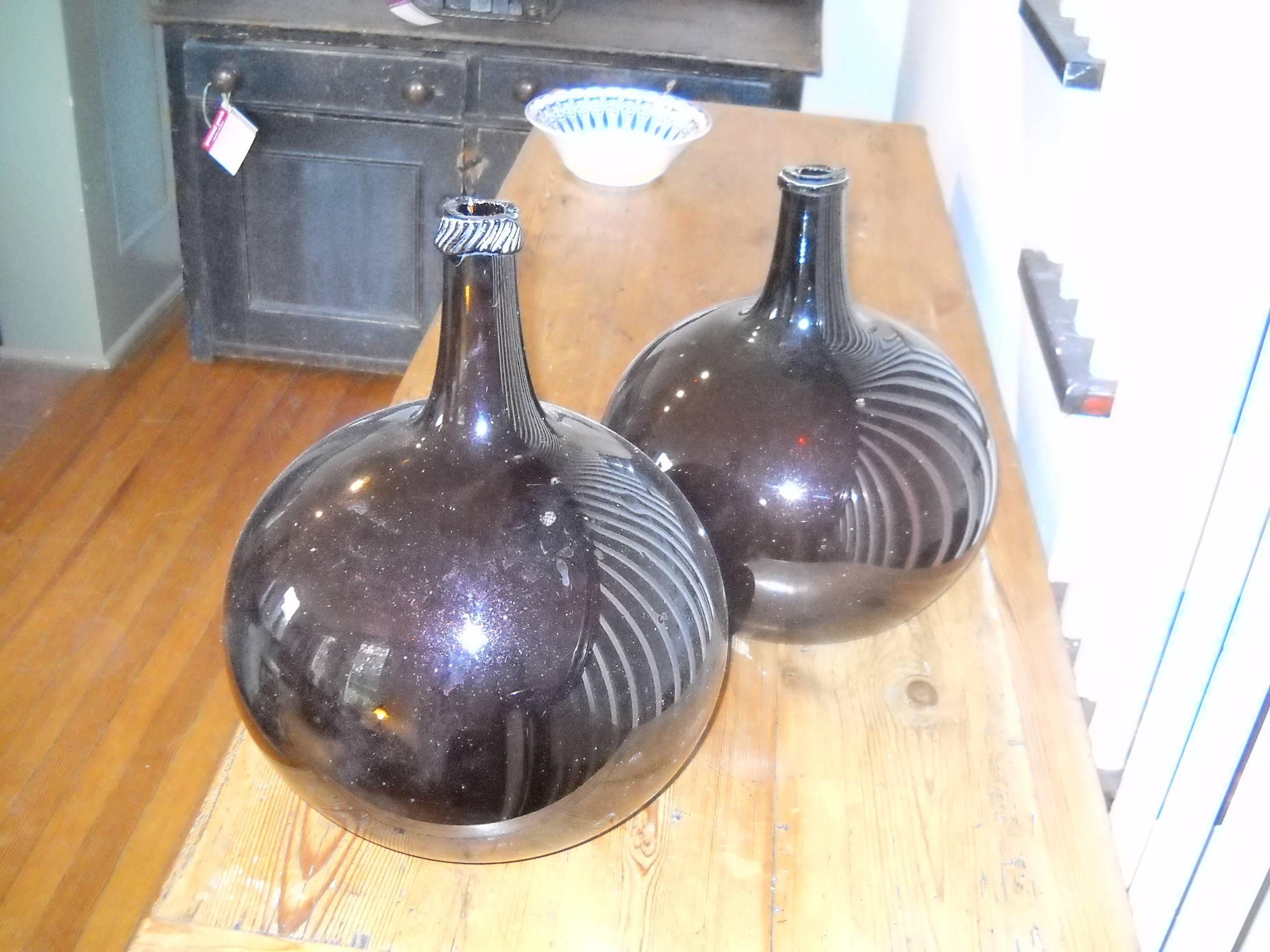 The amber color and shape of these wine jars are far more rare and these are two unique shaped wine jars, which are sold as a set.