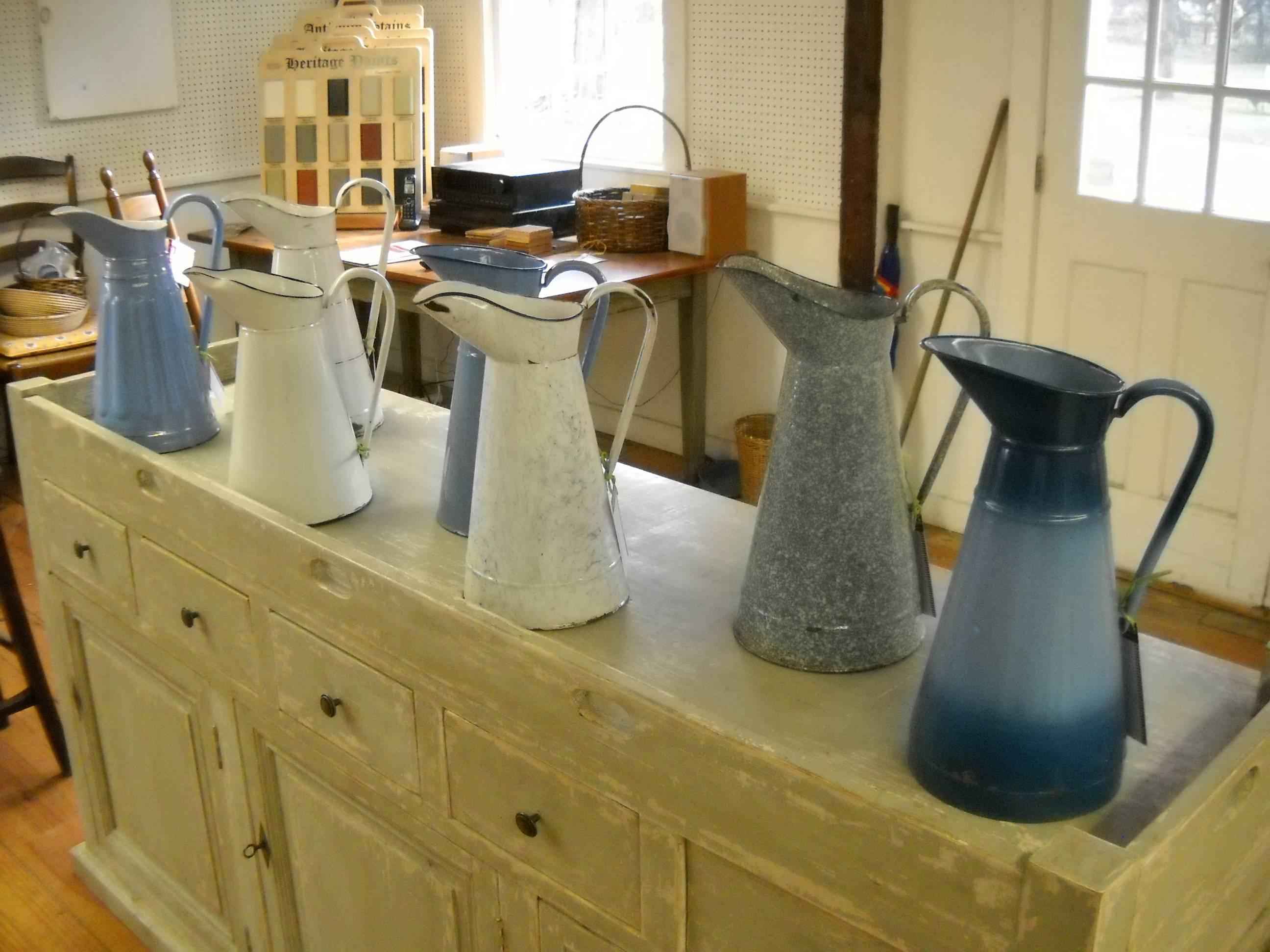 These are half of our French pitchers. We currently have 14 pitchers and these are seven of them. They are sold individually and each is unique and very special. They are all a similar height and diameter. This is the best collection of pitchers we