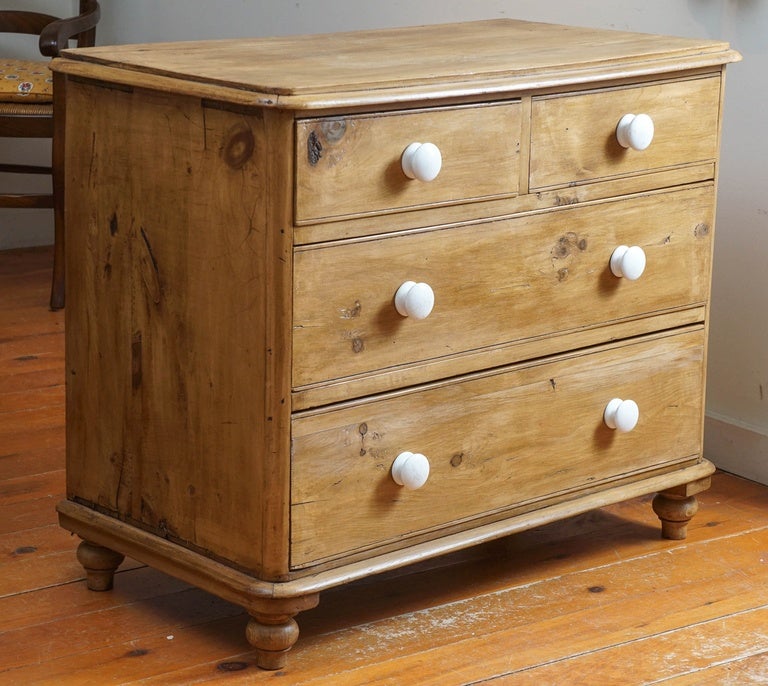 This pine chest of drawers is a sweet piece with original porcelain knobs. It is not a massive piece and could also be used as an end table. Two small drawers over two larger drawers and a very nice patina and very well priced.