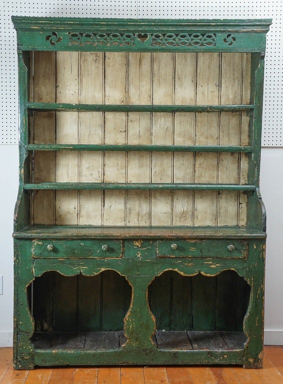 What a wonderful Irish cupboard this is. So romantic with touches of scallops in various places. This piece has everything. Plate rails, original paint, drawers for storage and storage below on a pot board shelf. The forest green color is