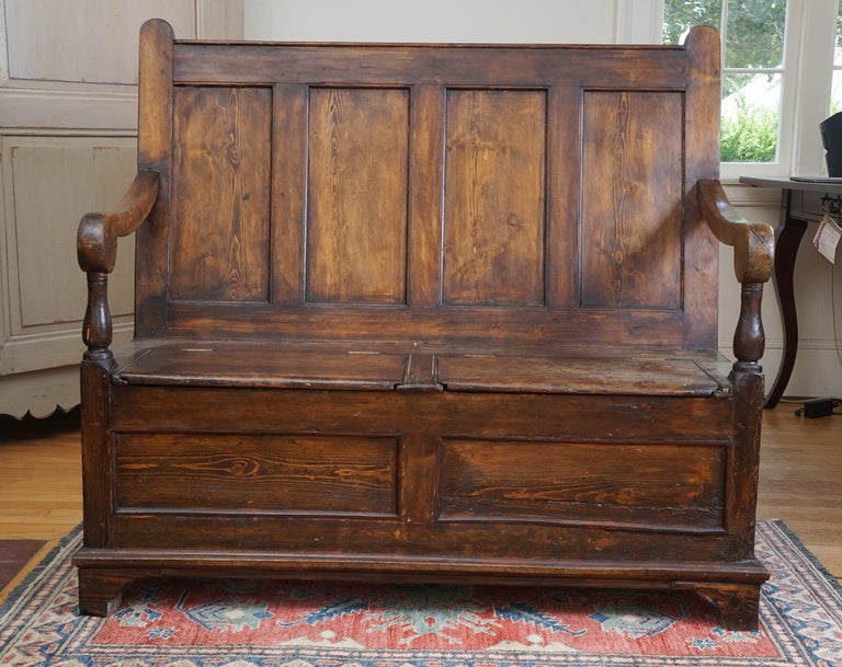 This unique monk's bench is in wonderful condition with a terrific deep brown patina. It is totally original and there are two seats that lift up for great storage. We see this in front of a fire place or in a mud room. Did I also say that it's