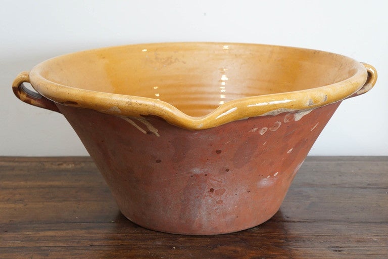 These batter bowls are large and heavy. A string was used on each handle to hold the bowl and then tipped towards the lip to empty the batter. This piece is stunning and would make a perfect center piece on a dining or kitchen table. The mustard