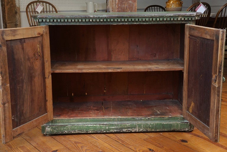 This two-door buffet came from the south of France and has the most exquisite green original paint. The molding surrounding the top of the piece is also quite stunning. Everything about this piece is original, including the shelf inside. You will be