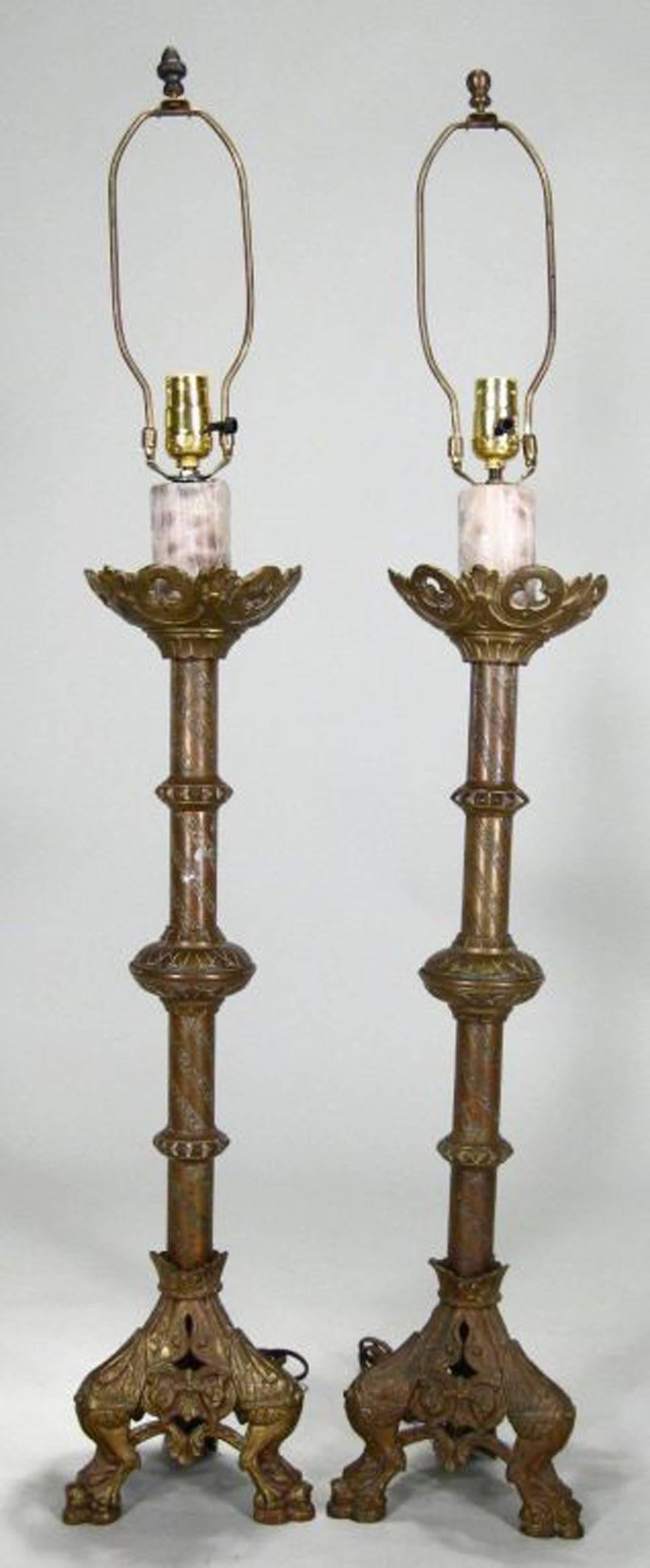 Pair of Gothic style brass lamps with lion mask feet, traces of gilding.